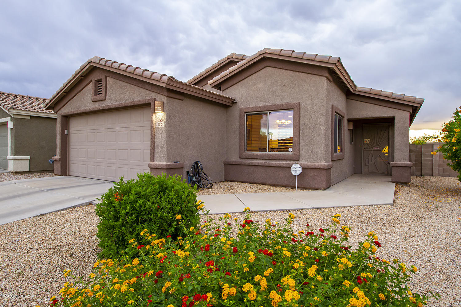 This home is a must-see and will sell fast! You'll recognize the pride of ownership once you walk in the door of this immaculate home. As you walk in to the family room you'll appreciate the open space, with custom wood shutters, and a custom screen doors at the front and off the back patio for enjoying those wonderful Tucson nights. This 3 bedroom 2 bath features tile flooring throughout, inviting paint colors, black appliances in the kitchen, epoxy garage floors, and an updated master bathroom with added storage. Enjoy those Mountain Views and sunsets from your backyard while you harvest your own veggies from the raised garden beds. This home is waiting for its new owners, take the opportunity to make an appointment and see it today!