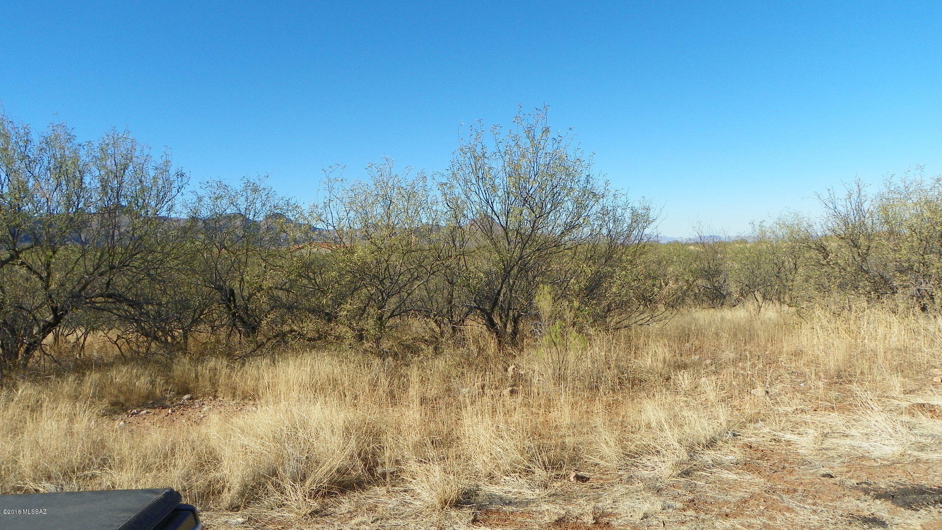 Fairly level lot with lots of homes nearby.  Paved road, great views, close to schools and highway entrance.  Utilities electric and water should be at the street.