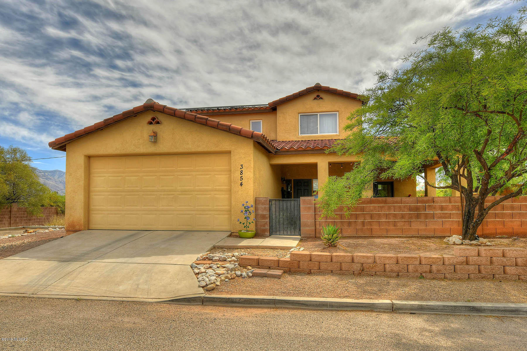 You don't want to miss this contemporary home privately situated in an enclave of 6 custom homes. Very open floor plan w/ extended outdoor living areas under wrap around porches. Take advantage of the amazing downstairs space that is ideal for entertaining. Even extended entertainment area through french doors to porch, indoor/outdoor living. Kitchen space has breakfast bar & SS appliances. Enjoy privacy upstairs with spacious master bedroom and 2 guest bedrooms. Master bedroom w/en-suite bathroom & walk in closet. Mature landscaping in the spacious yard gives you a private oasis to enjoy year round, soaking tub and fire pit included! Luxurious contemporary living minutes from Banner Hospital and UofA campus. 2 blocks to mountain ave & bike route. These homes are rarely available.
