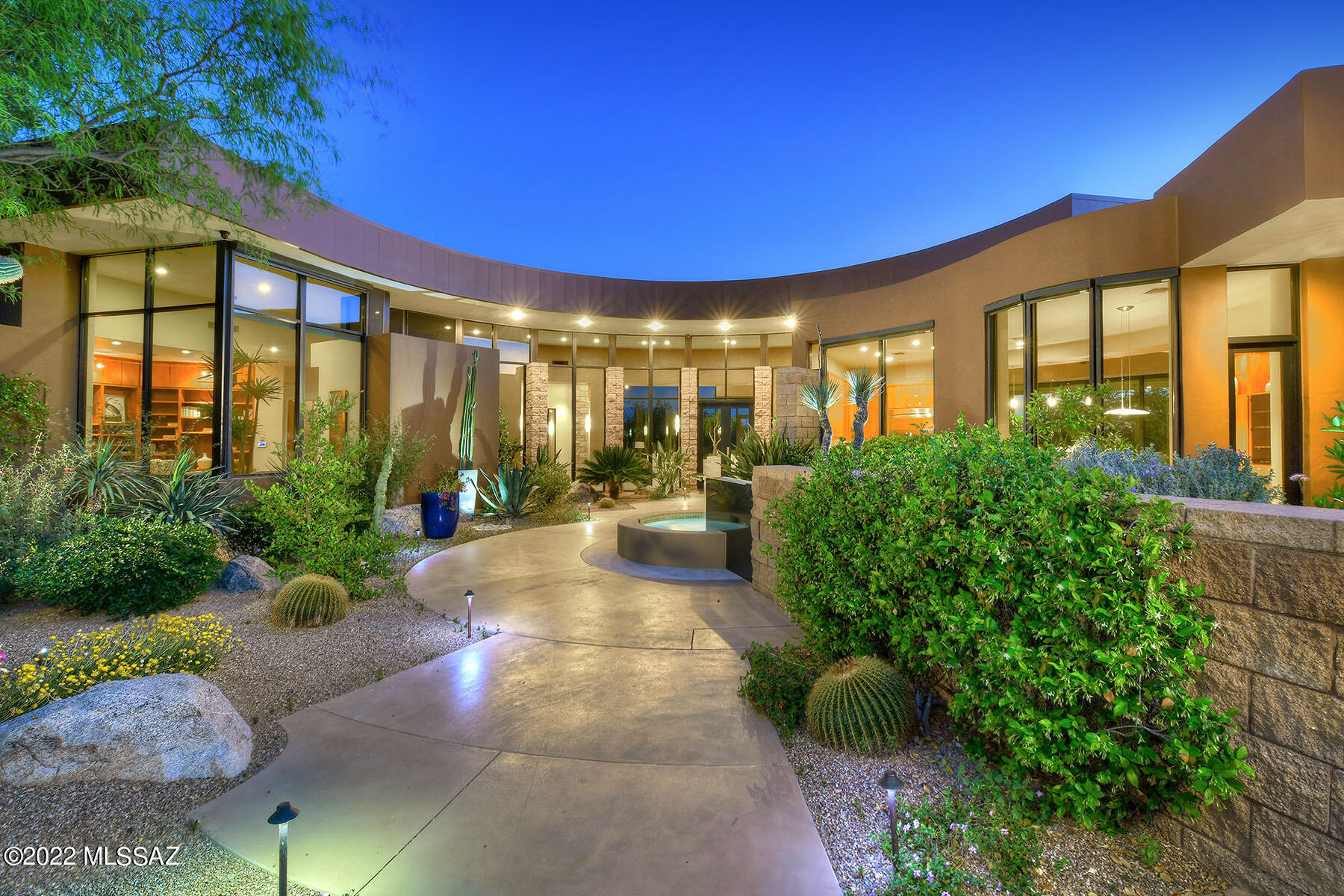 Stunning & sophisticated contemporary by architect Kevin Howard, lush vegetation & majestic mtn views on 1.4 acres in prestigious gated Reserve at Pima Canyon Estates. Dramatic combination of steel, commercial grade glass, 14ft ceilings & polished travertine flrs create a gracious ambiance. Front courtyard w/water feature, 5,648 sqft in main house. Exquisite living rm & dining rm w/fireplc & high ceilings, Gourmet island kitch w/cherry wood cabinets, granite countertops, stainless appliances, gas stove, 2 dishwashers, dbl oven, brkfst area, fam rm w/fireplc & wet bar, 4 bedrms + study w/built-in bookcases, 5 baths, master w/fireplace ,lux bath, lg walk-in closet, priv patio + 538 sqft guest house w/bath. Resort bkyd w/covd patio, pool, spa, frplc, BBQ, city viewing deck, 3 car gar & Views!