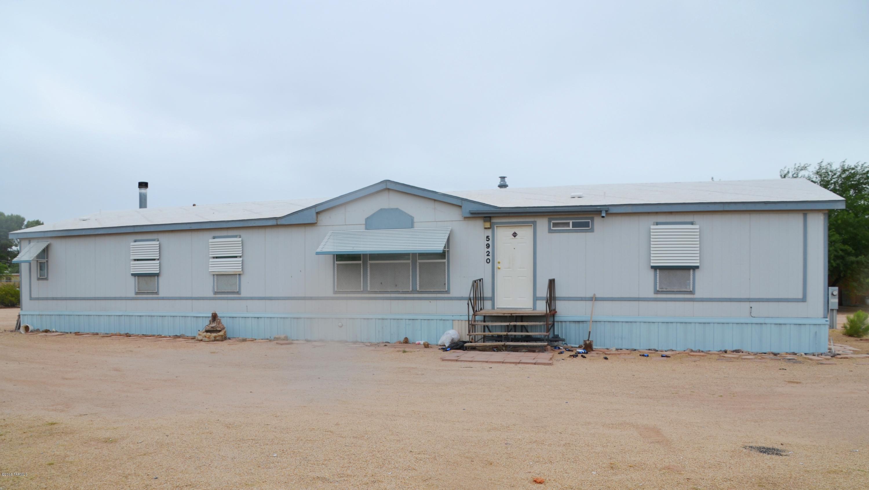 Wonderful 4 bedroom 2 bath manufactured home, affixed, tied down and skirted. Open and bright with vaulted ceilings and fireplace. Features large kitchen with island and ample cabinet space. Master bath has a garden tub. Resting on almost an acre and fenced in. Property is R-2 zoned, great development potential. MOTIVATED SELLER!