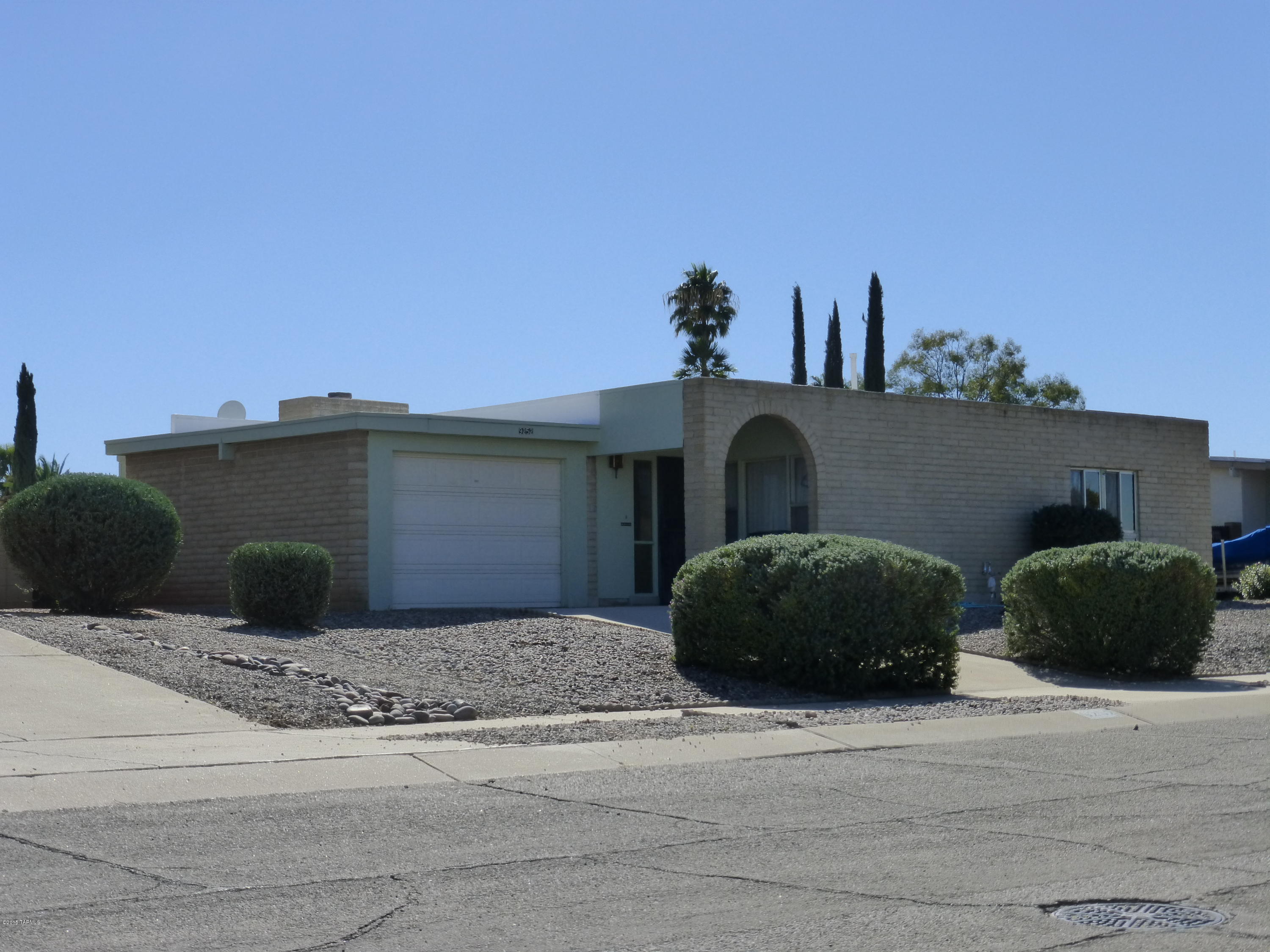 Don't miss your chance to see this delightful three bedroom two bath solidly built masonry home in the desirable Hidden Hills subdivision. You are going to love the block wall that surrounds the back yard and gives you privacy to the pool area.  There is also a double gate that gives you easy alley access to the nicely landscaped back yard that features a sparkling pool and a screened in patio that is ideal for entertaining. For those hot summer days there is an ice cold air conditioning system. There is also a one car garage and this classic home is nestled on a large lot and is secluded yet conveniently located just a couple blocks north of Speedway.