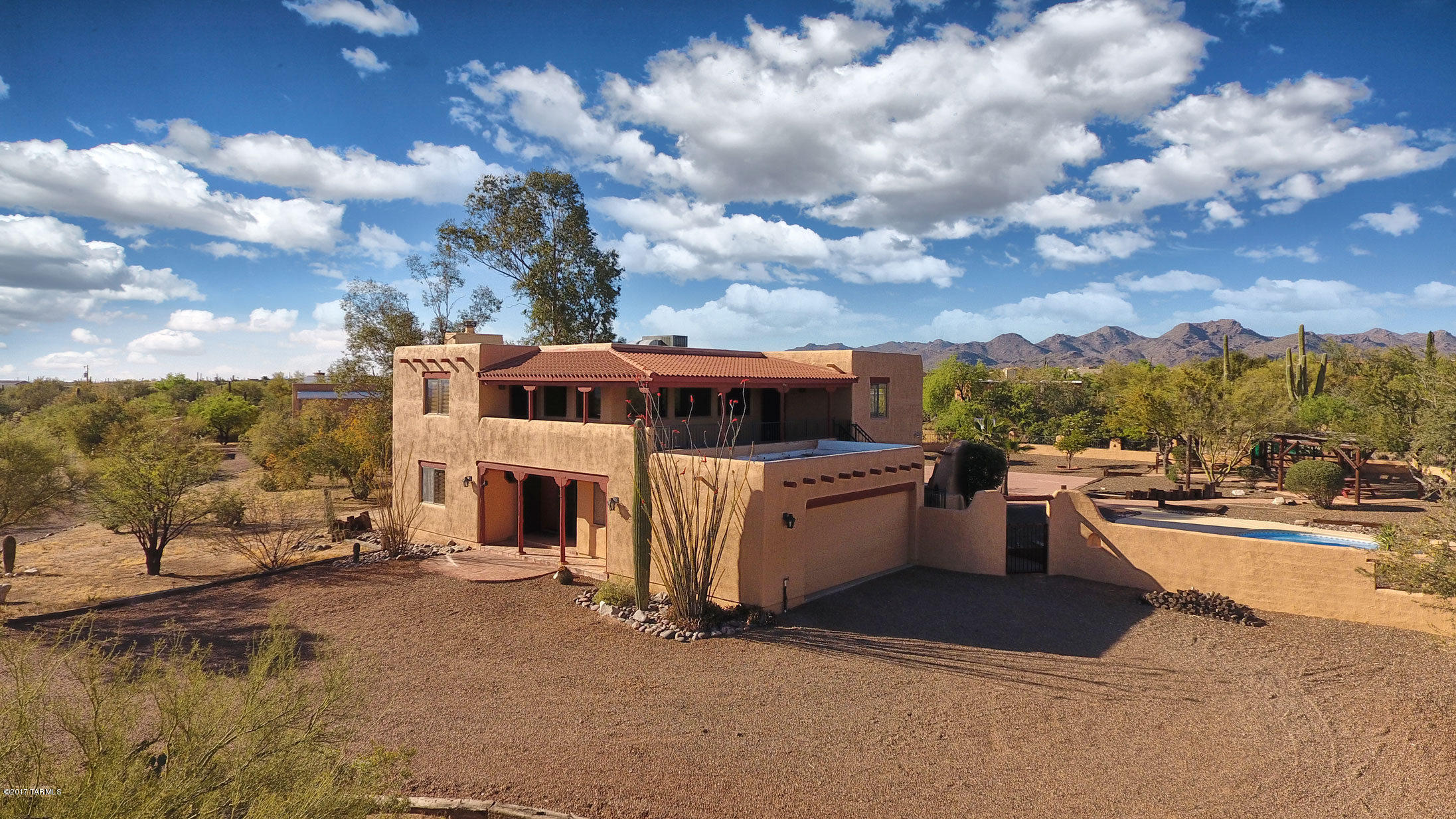 JUST REDUCED PRICE $25,OOO.Wonderful hacienda style horse property in convenient NW Tucson location. 3.34 acres features main house, guest house w/attached studio, 2 car garage plus separate RV carport, pool and spa.
Large front foyer with saltillo tile throughout 1st floor. Living room with natural wood fireplace, wood ceiling, and built in shelves. Formal dining room with natural wood ceilings. 
Large kitchen, all appliances convey! Corian countertops, dual sinks and custom cabinetry. Half bath off kitchen.  Large separate laundry room.
Steps to upstairs bedrooms are saltillo tile with stair lights on the wall.
Master bedroom has saltillo tile thru-out with large walk in closet. Mountain views. Full master bath with custom dual sink fixtures and vanity. Large covered "L" shaped patio off master suite to enjoy panoramic mountain views!
Hallway on 2nd floor saltillo tile. Full hallway bath. Bedroom 2 & 3 wood laminate flooring, mountain views. Bedroom 4 saltillo tile and separate entrance to covered "L" shaped balcony.  All beautiful mountain views.
Detached 300 square foot guest casita has an attached 1,000 square foot studio. Casita has carpet floor, small kitchen area and full bath. Loft bedroom upstairs. Casita connects to large studio.
Great outdoor entertainment with built in grill, fireplace.  Enjoy the basketball area then cool off in the sparkling pool and spa. Mature landscaping all around the backyard including two orange trees. Follow the walkway from the backyard to the casita and covered RV carport. Off to the side is a fenced in dog training area that can be converted to horse facilities.
Property has two septic tanks, one for the main house, one for the guest house.