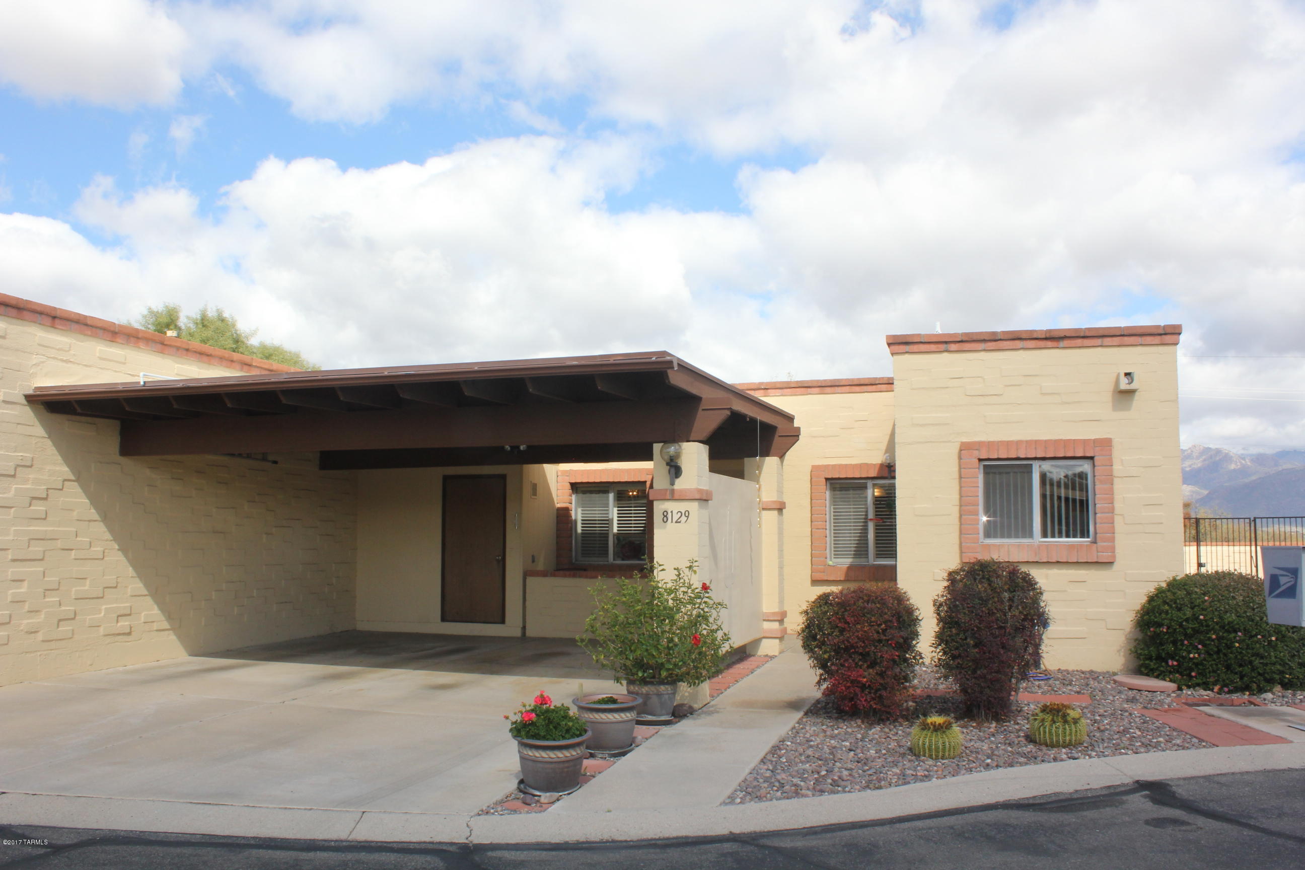 Meticulously maintained town home in popular NE community. Features include remodeled Kitchen w/raised panel cherry cabinets, SS appliances, lots of  counter space. Cozy eating area in kitchen is perfect for gatherings. Custom wood flooring, neutral colors & plenty of light throughout. Master suite hosts walk-in closet & sliding glass door leading to rear patio. Mstr.Bath w/walk-in shower w/granite surround & exec height vanity. Spacious living Rm. w/corner fireplace opens to private rear patio w/custom brick pavers. Rear gate opens to community common area. Enjoy the best of AZ outdoor living without the maintenance. Move in ready!Don't miss this rare opportunity to own on this popular community. HOA includes, trash, ext. paint, structural insurance
