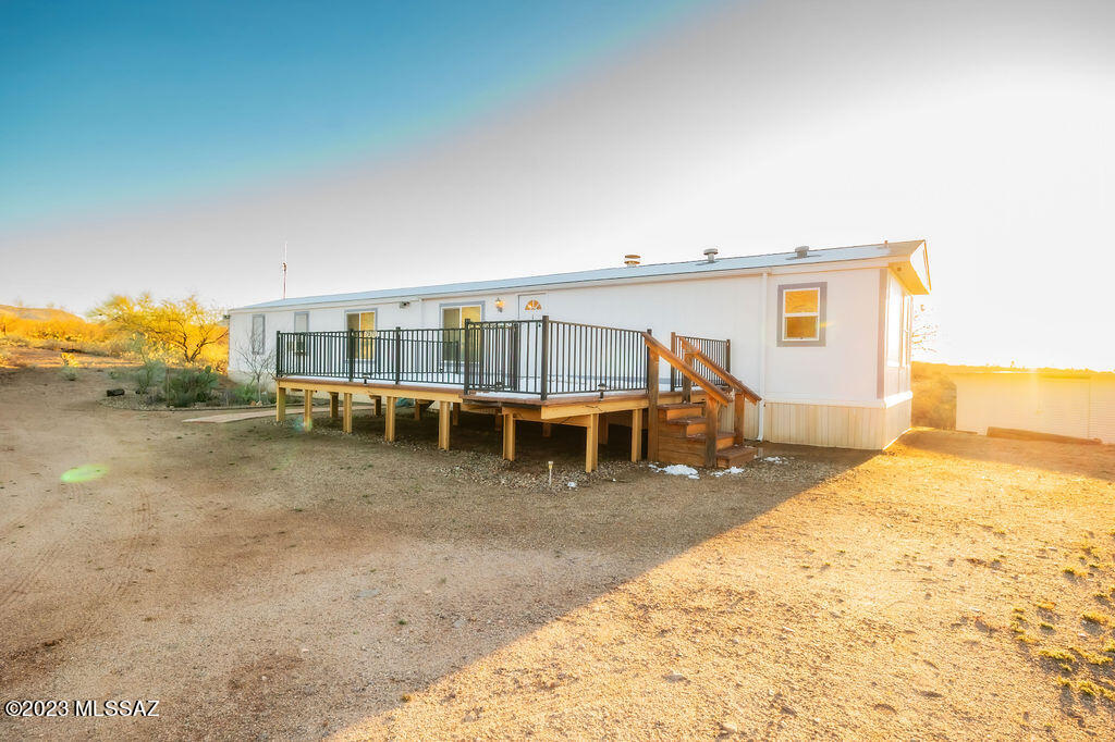 Look no further because this exceptional manufactured home is the one for you! This magnificent 1 story home built in 1996 is located at the base of Saguaro National Park. At 1,120 sq ft, you have 3 bedrooms, 2 baths, and 5.08 acres of natural area open space! This home is in immaculate condition and offers beautiful mountain views. The rear of the property is protected state land which insures your views. Enjoy having newer windows that are UV insulated as well, working appliances and updated flooring matching throughout the home. The roof of the home was redone in late 2021 and the home is wired for security cameras. Upon arriving at the home you will find a beautiful, spacious, steel framed balcony. This is the perfect spot to stargaze or even to add a hot tub of your choice. The interior layout is designed for relaxation! Upon entering, you have a wood burning fireplace with a working fan to direct the heat as well as a family great room. Enter into a beautiful backyard that is gated and surrounded by vegetation to offer a serene and quiet escape. The backyard comes with a shed for your landscaping or workshop needs and a relaxing fire pit with a custom built steel log holder. Located at the base of Saguaro National Park, this home is the perfect place for people who are looking to live in their own desert oasis away from city life. This house is ready to move in so don't wait any longer!