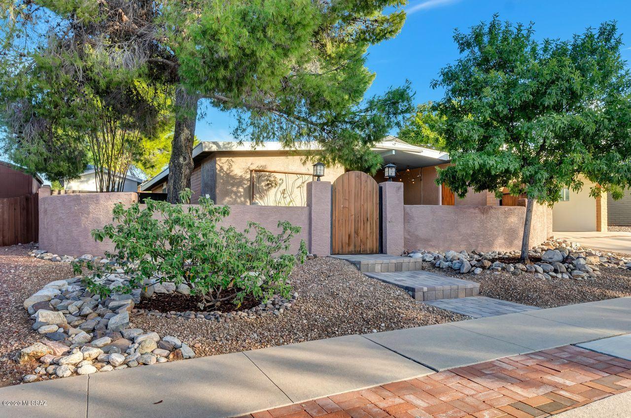 Contemporary yet casual w/relaxed ambiance, this NE home offers a private & peaceful setting inside & out. Versatile floorplan features updates & renovations incl/a stacked stone fireplace in LR, stainless steel appliances, unique one-of a-kind island, open kitchen layout to both dining area & family room, high end Pergo flooring throughout common areas & bedrooms; extra room can be used as a sitting room, office, nursery, guest room. Enjoy outside living spaces including expansive covered rear patio w/mountain views, covered front patio; courtyard & an additional private patio area located on side yard, mature low-maintenance landscaping front & back, raised garden & plant beds w/artificial turf spaces. Generac backup power, solar panels, water softener and RO water filtration systems.