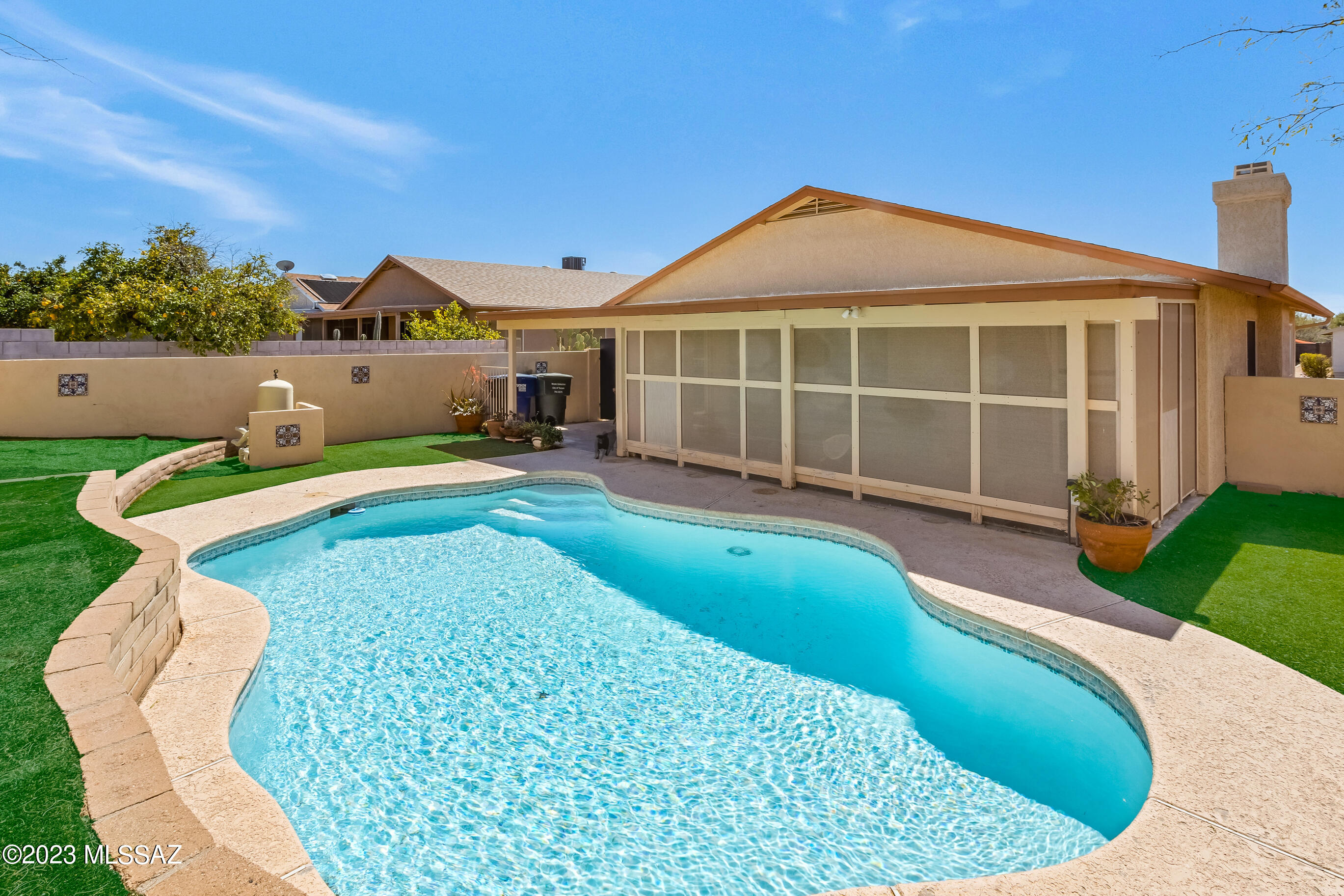 Range Pricing. Seller to accept/counter offers $300,000 to $325,000. Don't miss this rare find on Tucson's eastside!  Enjoy this updated 4-bdrm, 2-bath split floor plan with tile throughout, spacious living room w/gas fireplace, upgraded kitchen includes quartz countertops and all appliances, oversized master bedroom, with walk-in closet and private back yard access. Security system included. Separate laundry room. Just in time for the warm weather, you will appreciate the beautiful back yard, pool & screen enclosed patio. All perfect for entertaining! Don't wait on this gem! Washer/dryer, mounted TV and curtains do not convey.