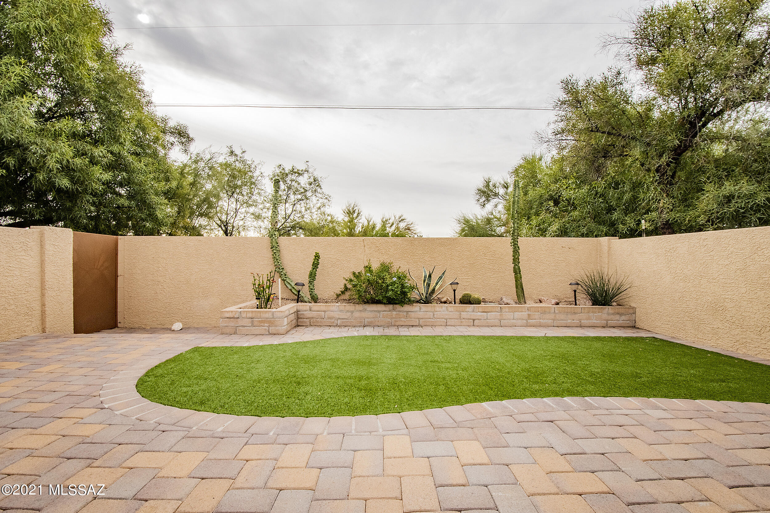 Just move-in and unpack in this fabulous 2 bedroom, 2 bath townhome centrally located in the quiet hidden gem of Sunset Ridge. This end unit has a 2-car garage, brand new HVAC installed 5/2021, new interior paint,  carpet, a gas fireplace, Saltillo tile, and remodeled shower in the master bath. Enjoy your relaxing backyard with paver patio, maintenance free artificial grass and unobstructed desert views. This community has beautiful, landscaped grounds with 2 pools and club house.  This is an amazing place to call home.  NO Poly Pipes, they were REPLACED in 2014 with copper!!