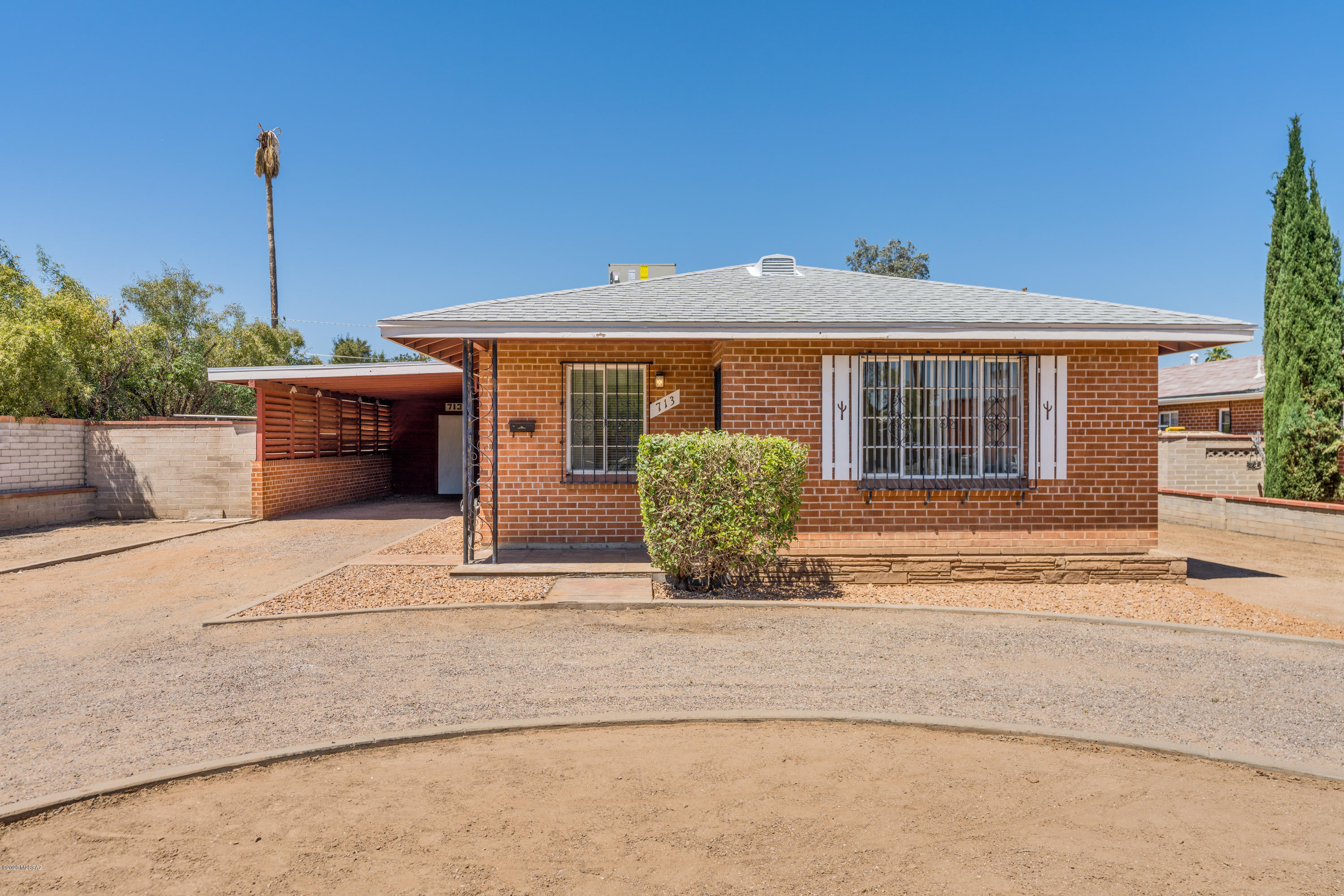 Adorable brick home centrally located 6 minutes from the University of Arizona!  Three Bedroom, 1 Bath with brand new roof, HVAC and updated throughout!  New carpet and paint throughout!  New oven/stove, refrigerator and stackable washable/dryer!  Stainless steel double sink!  Refinished bathtub, new toilet and mirrored medicine cabinet!  Single carport and attached shed!  Covered patio, brick pavers and spacious backyard with orange tree and mountain views!  Call today for your private showing!