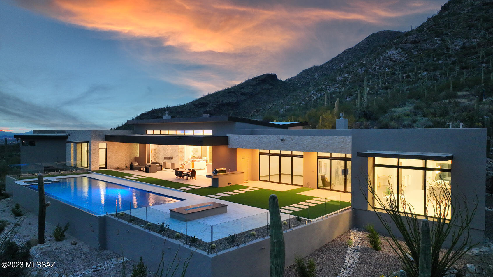 Immerse yourself in the pinnacle of luxury living with this expansive 5,661 sq. ft. residence, proudly nestled on a saguaro-studded 3.26-acre elevated lot within the coveted Pima Canyon Estates. This striking home, a testament to the architectural prowess of Marc Soloway of Soloway Designs, blends modern elegance and practical functionality, framed by awe-inspiring panoramic views of the city and the surrounding mountains.

This remarkable property features four generously-sized bedrooms and five bathrooms, each providing a tranquil sanctuary for rest and retreat. An accommodating office and exercise room add an extra layer of versatility to the home's sophisticated layout.