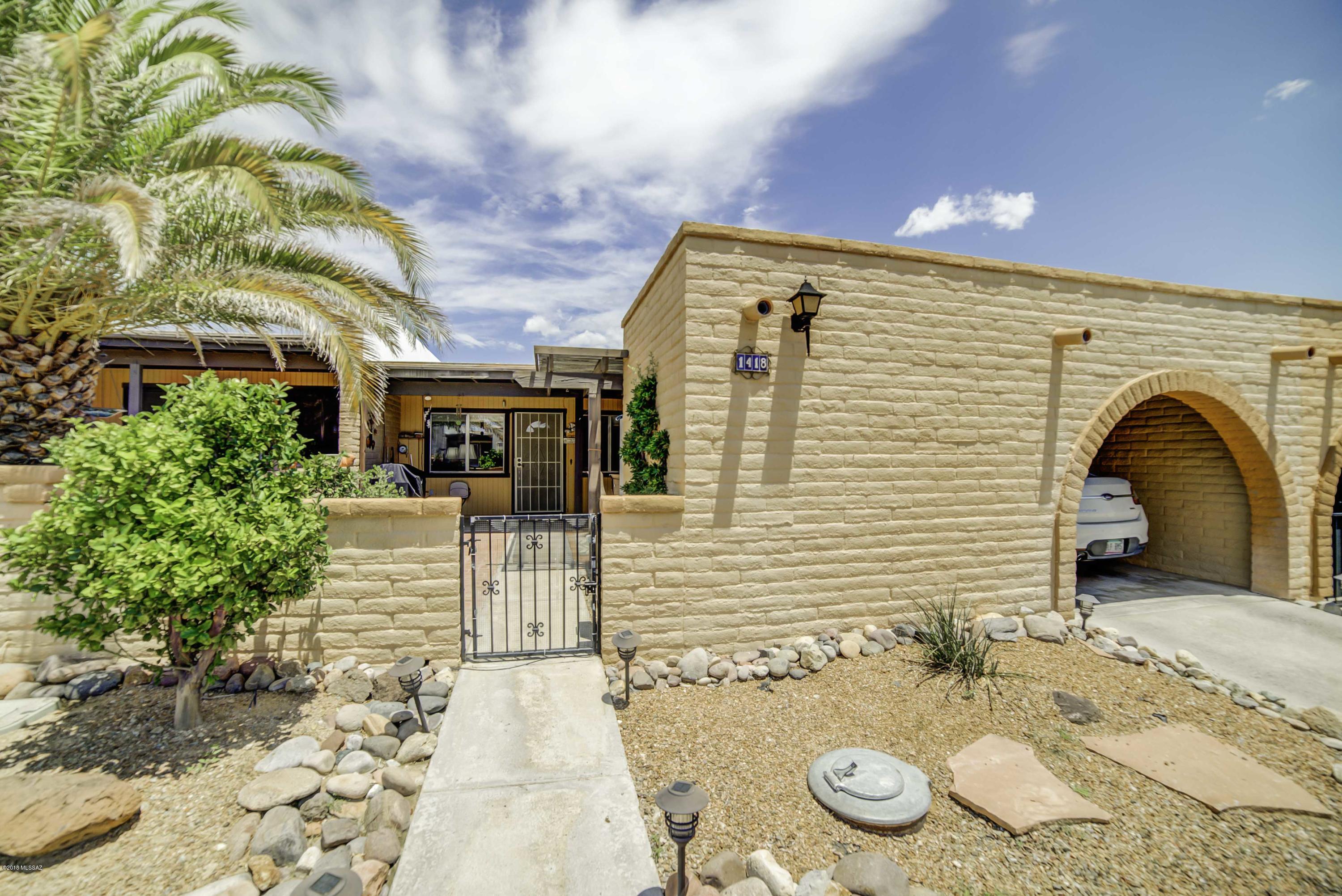 The sturdy territorial block construction means low maintenance and solid insulation.  Walk through the front courtyard gate past the lemon and kumquat trees to find a peaceful place for relaxing under a cool breeze Spanish Ramada.  This easy living floor plan features wood laminate flooring extending into a corner dining area with a pass-through serving window to the kitchen.  The roomy kitchen is drenched in natural light from a large skylight.  It has an efficient layout with white cabinetry and drawer pullouts and features a GE Convention range and Frigidaire side by side fridge.  The extended space in your master bedroom gives you a reading area or room for a computer station.  Both baths have been updated with executive height vanities and master shower surround has been replaced. Hobbyists and mechanically minded individuals will love the workshop where you can escape in solitude to express your artistic skills.