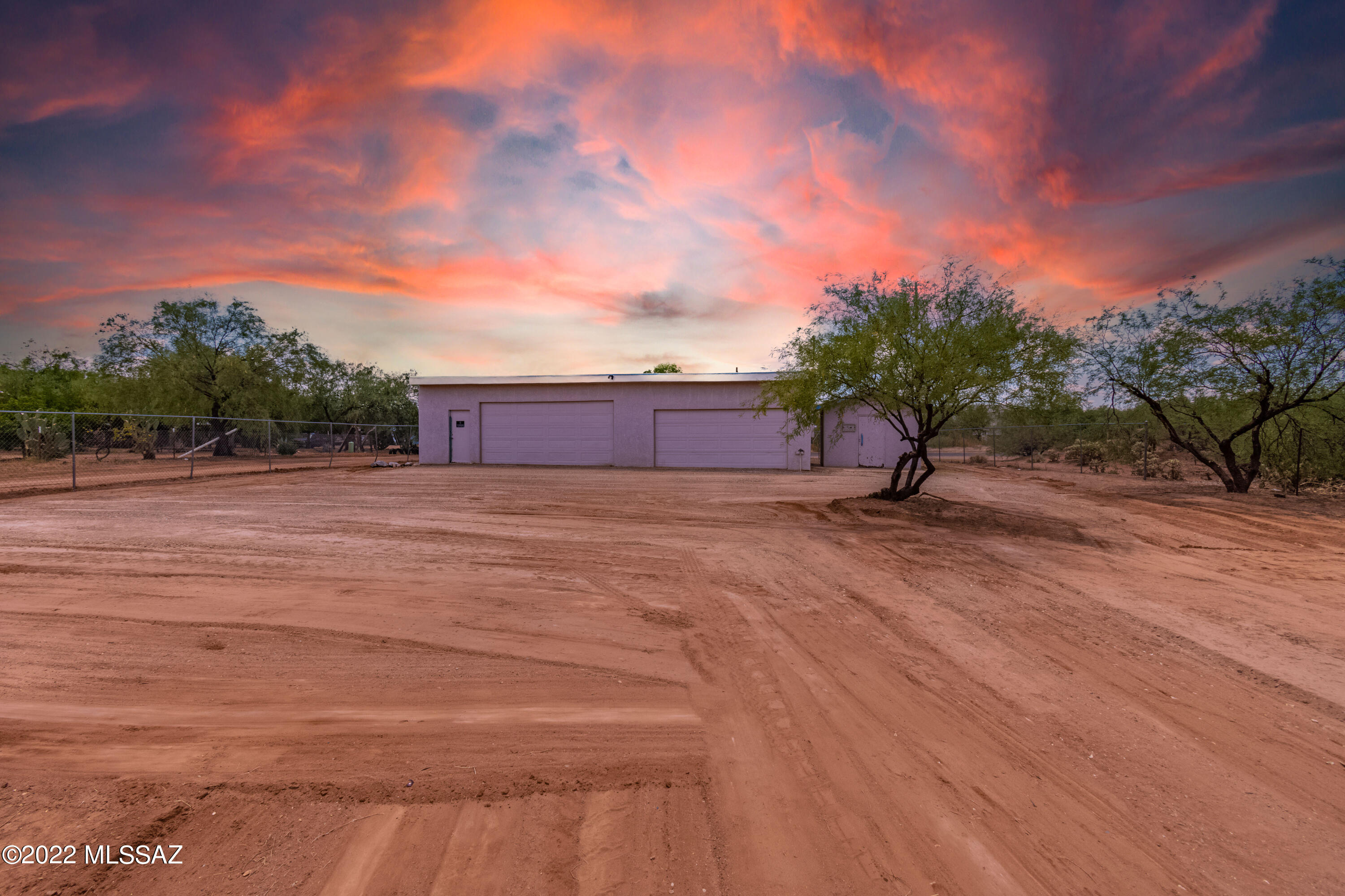 RARE FIND!!!  Fully fenced flat acre lot available now off paved road!  There is currently over size 4 car garage building with 2 double garage doors and storage shed on site.  Main building is 1,000 square feet (50x20 per owner) and can be turned into a house or you can build your custom home on to garage.  Currently no septic at property since this building was used as storage.  No HOA and horses are allowed! Property has a shared well agreement in place and electric installed at site!  Bring your plans and imagination to this private and unique property and build your own custom home!  Close to to shopping, schools and freeway. 3 miles from I-19, don't miss out on this rare opportunity!