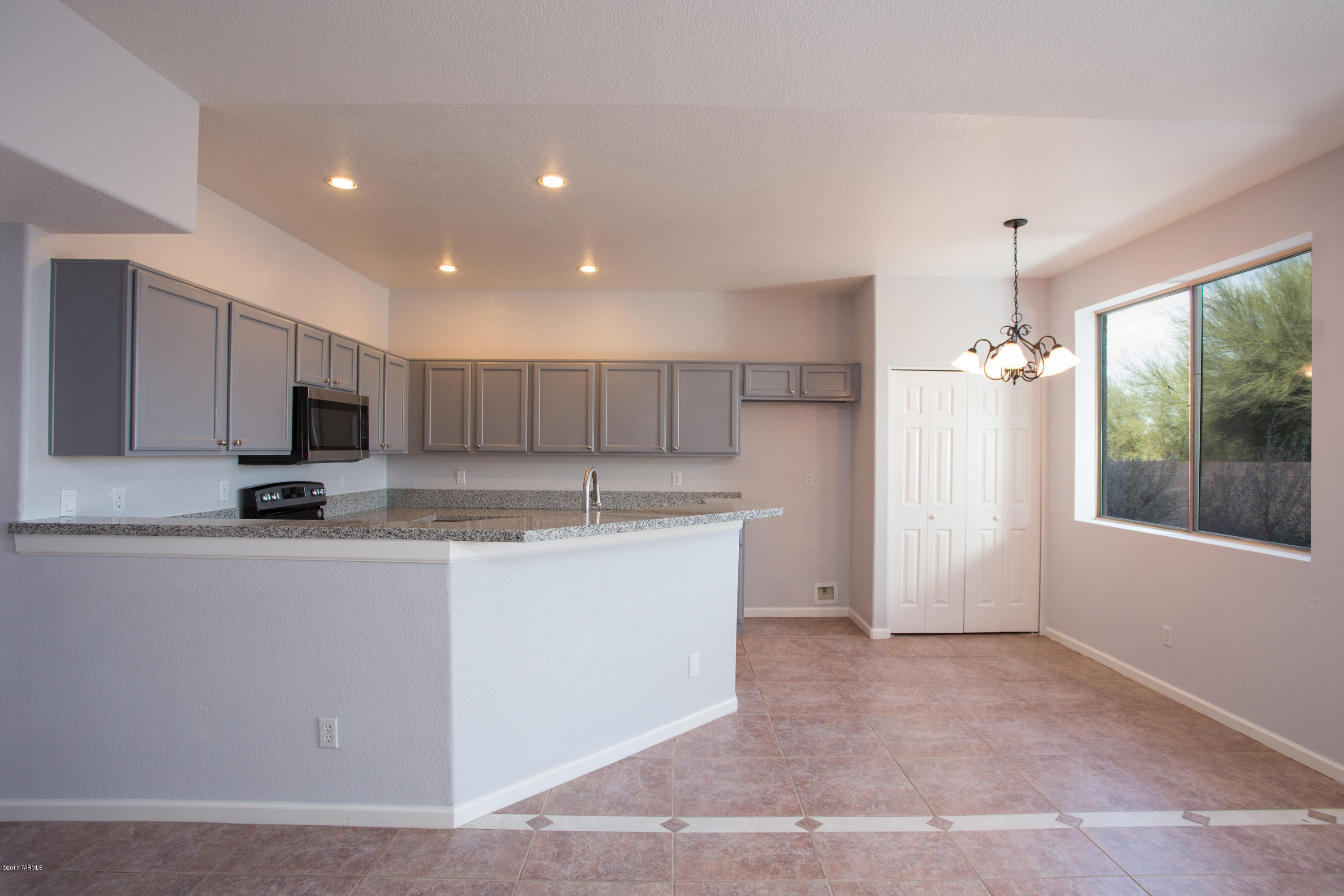 Seller will accept/counter offers from $219,900-$229,900. GORGEOUS & CAPTIVATING 4BD/3BA Rita Ranch home with Stunning Mountain Views and a great OPEN FLOOR PLAN! Remodeled home has tile floors throughout the first floor, 2 Living Areas, gourmet kitchen with granite counter tops, new stainless steel appliances, family room with a fireplace and large windows. Walk into the  master suite through the dual french doors, large walk in closet and a massive master suite bedroom with a private deck that has amazing views. Plus Master Suite bathroom w/dual vanities, garden tub and a  beautiful new shower. New Carpet and Fans plus gorgeous new tile shower enclosures in both guest bathrooms. Large 2-car garage with tons of cabinets for extra storage, private backyard fully fenced for privacy. No Poly
