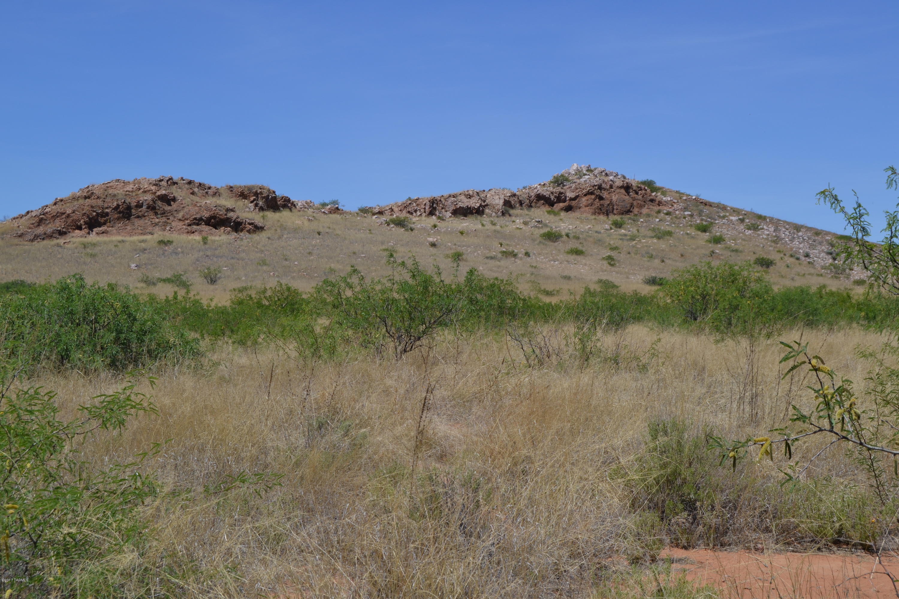 Secluded and tucked between the hills makes this property the absolute PERFECT spot to build your dream house and call this home! This
isn't your typical flat property in the desert. This property has it's own mini mountain plus lots of level ground for building. It is fenced on one side, has total of 5 parcels
already split with easements so you could sell them off if you chose to. Gorgeous and private but still easy to get to. Not far from the Chiricahua Mountains as an
added bonus!