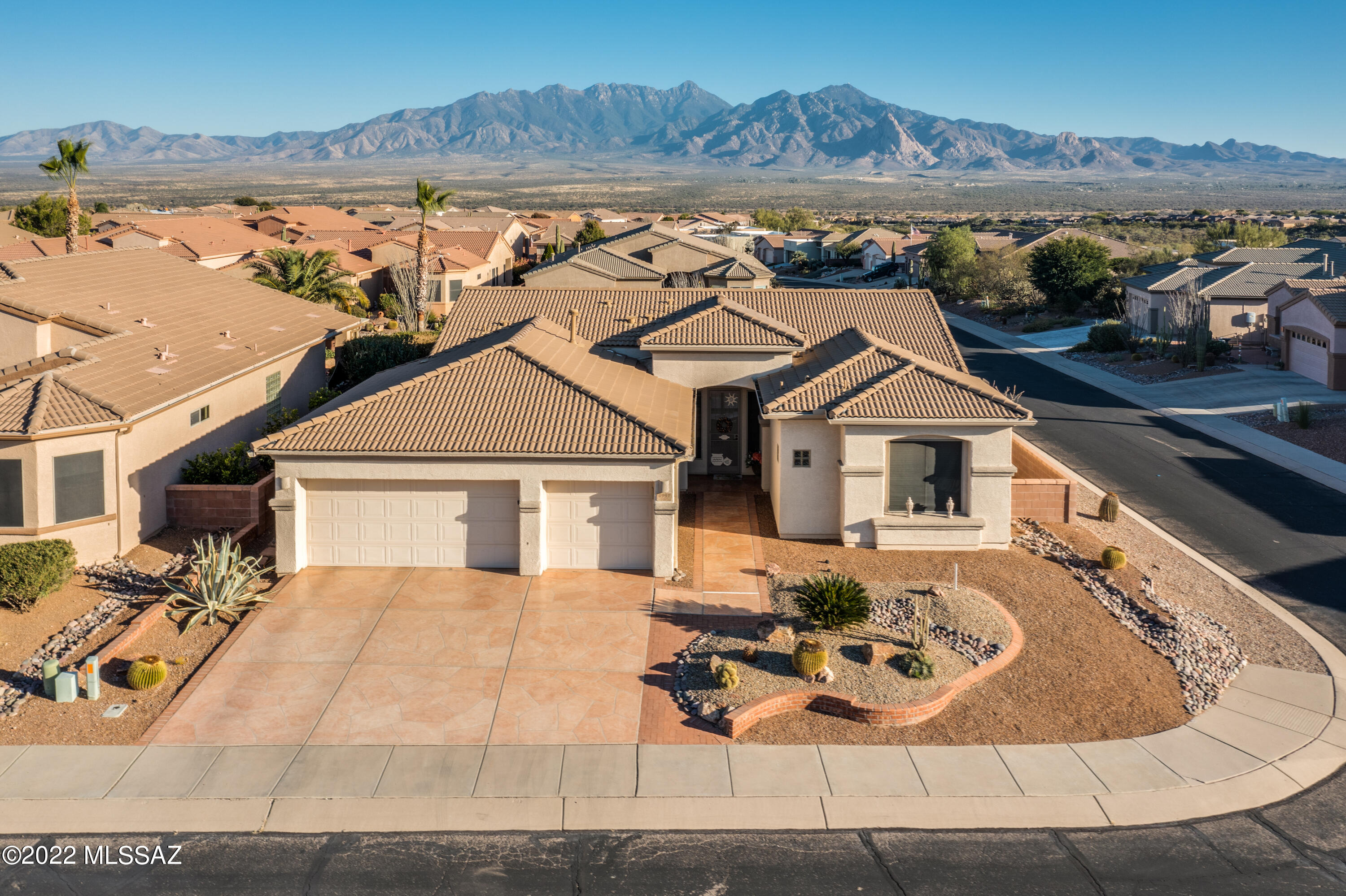 Stunning Mediterranean style home situated on a spacious corner lot with outstanding Mountain views! Spacious rooms throughout. Extended 3 car garage with workshop space and cabinets.
 This meticulously maintained home has a newly replaced tile roof w/double underlayment, new water filtration system and luxury vinyl plank flooring in living room & den. Both bathrooms have been updated w/travertine tile showers & executive height vanities w/granite counters. The extended covered patio features beautiful pavers & remote controlled sunshades. Spend endless hours relaxing and entertaining on the patio enjoying the beautiful views. This home is located close to the newest GVR Center that offers a wonderful fitness center w/ pool, spa and pickle ball courts. 2017 A/C. Many furnishings included