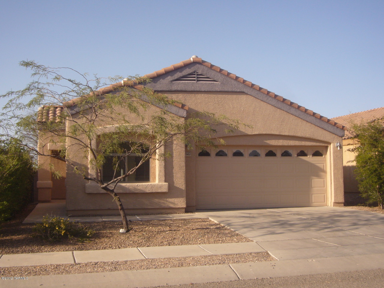 Super fresh with new paint & carpet! Very clean and well maintained 3 Bedroom 2 bath home in newer West side neighborhood. Great location close to I-10, UofA, Pima Community College and downtown. Large great room floor plan with master bedroom separate from the guest bedrooms. Master bedroom has 2 closets (one walk-in) with double vanity sinks and garden tub in the master bath. Kitchen has toffee colored maple cabinets, Corian countertops, large pantry, and breakfast bar. Other features include decorative wrought iron security door at front entrance, wood blinds throughout, laundry room with washer and dryer hook-ups, alarm system installed, plus a covered patio and mature trees in the private back yard. Non-smoking home. No pets. 1 year minimum lease.