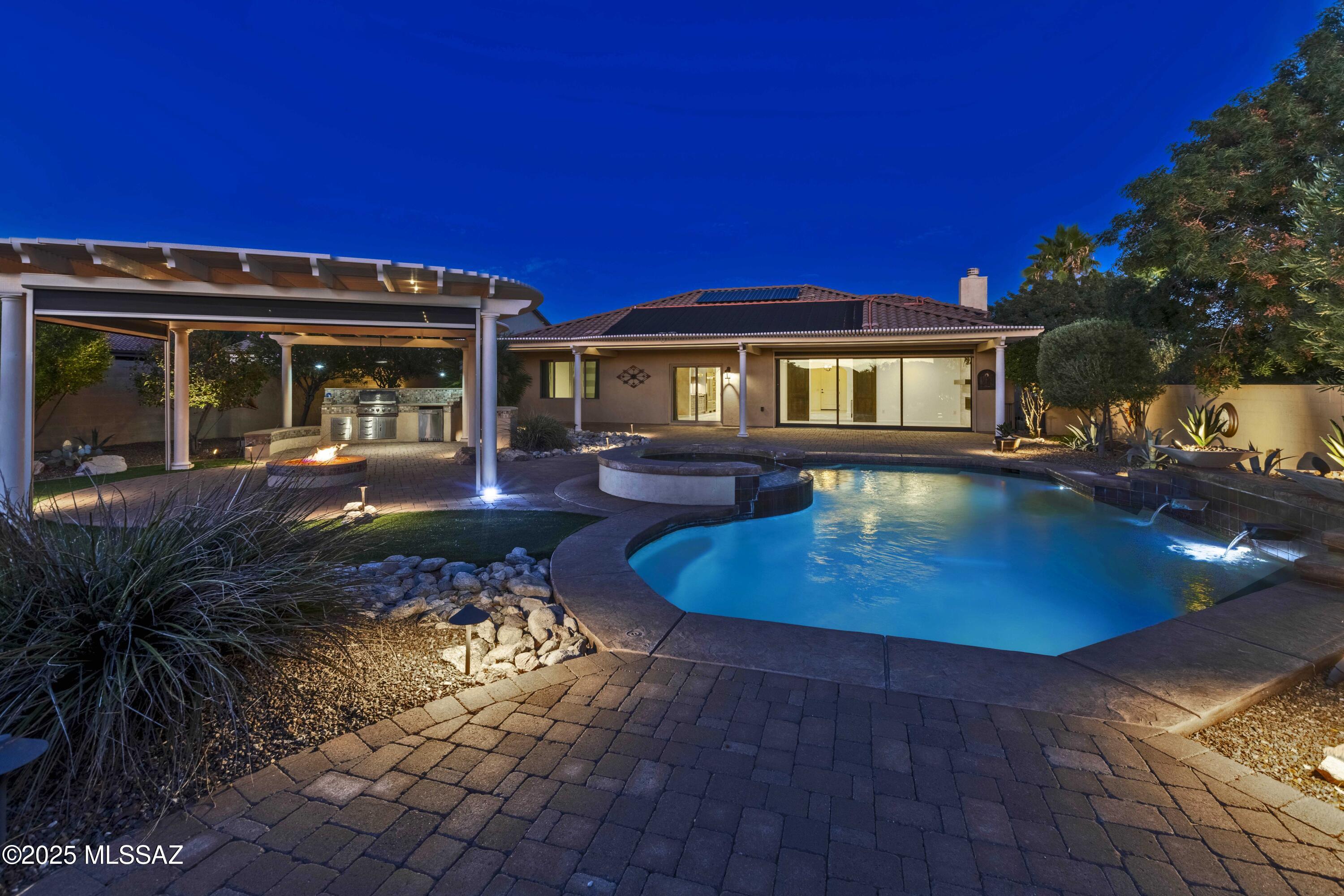 Explore this beautifully custom designed private oasis offering the ultimate in comfort and elegance. Luxurious secluded resort style backyard has expansive pergolas providing shaded retreats while a sparkling pool and spa invite you to unwind in refreshing coolness.  Inside the custom-designed kitchen features Sub-Zero, Bosch, & Wolf appliances.  The buffet breakfast bar is ideal for effortless entertaining, seamlessly connecting to the spacious dining area & great room. Adjacent family room can be made cozy by the fire or, anchored by a dramatic window wall, opens up gracefully to the rear patio & lush yard beyond. A spa-inspired bathroom showcases a curbless shower & dual custom walk-in closets.  Thoughtful upgrades enhance every corner of the home!  Come see true luxury for yourself!