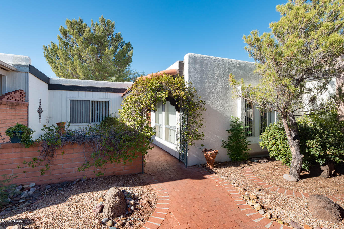 Located in the growing community of Green Valley.  This townhouse has been upgraded with  wood looking ceramic floors in living room and bedrooms, new washer and dryer purchased in 2018, ceiling fans added and back porch painted.  All appliances stay.  Mature trees and vegetation add to the serenity of porches both in the front and back.  This property is located next to the common area so no close neighbors. It's a quiet piece of paradise to call your own.