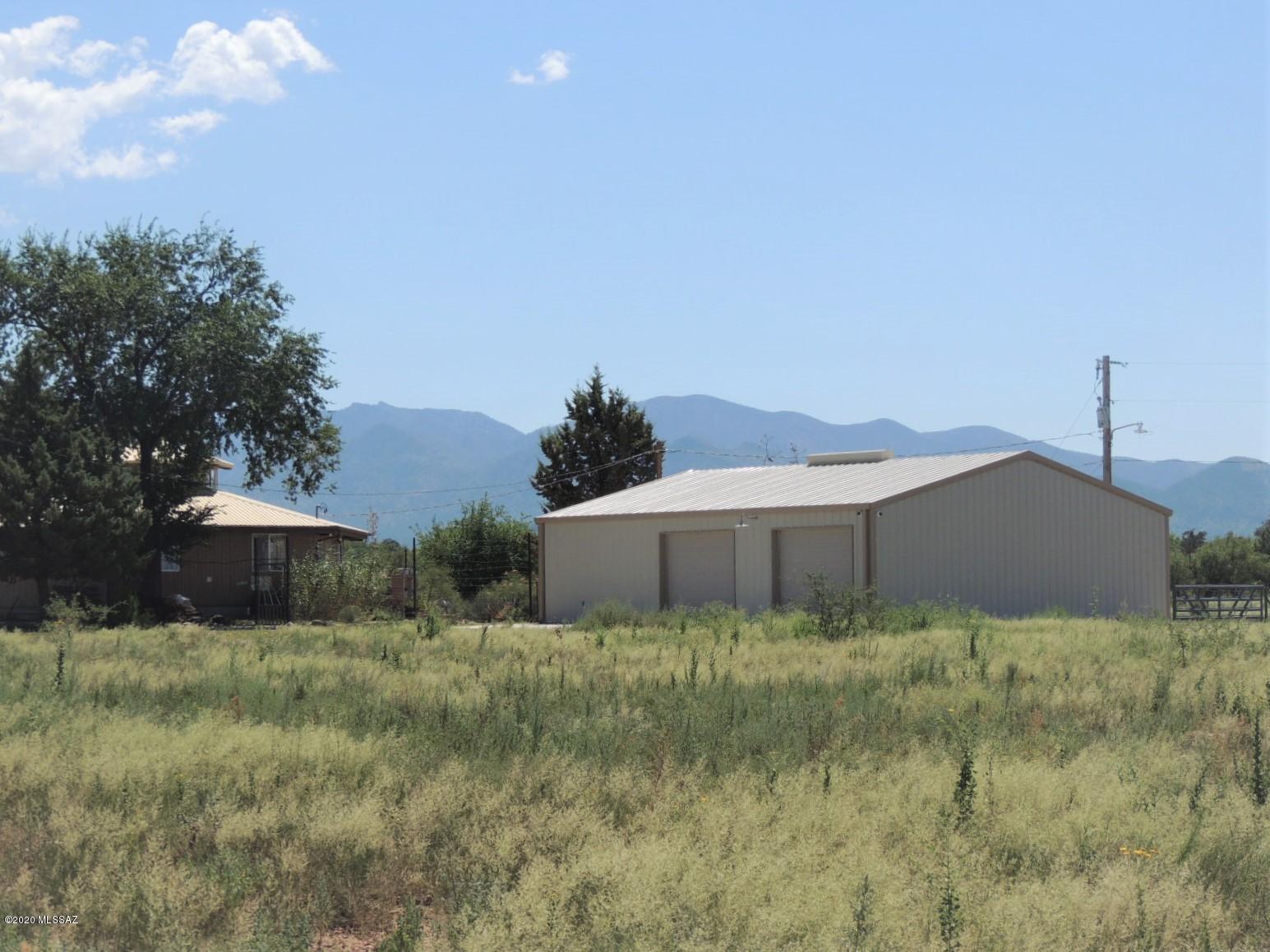 FENCED HORSE PROPERTY WITH AMAZING MOUNTAIN VIEWS! You will be intoxicated with the natural beauty of this 54+ acres that sits among the oaks on Rock Creek in the foothills of the beautiful Chiricahua Mountains. The octagon home is beautiful and unique. Seller has added a Mueller 40x35 4 car garage/workshop with attached 15x40 Guest suite with full bath. Fabulous flagstone patio. The views are magnificent and 360 degrees. This is wine country at its best! The seasonal creek flow also makes it very attractive to birders, hikers & star gazers. The seller has cleared the acreage for grazing or possible agriculture growth. The weather is perfect with no prolonged heat or cold, while supporting 4 seasons.    
Seller has an additional 40 acre parcel available for sale 1 mile south.