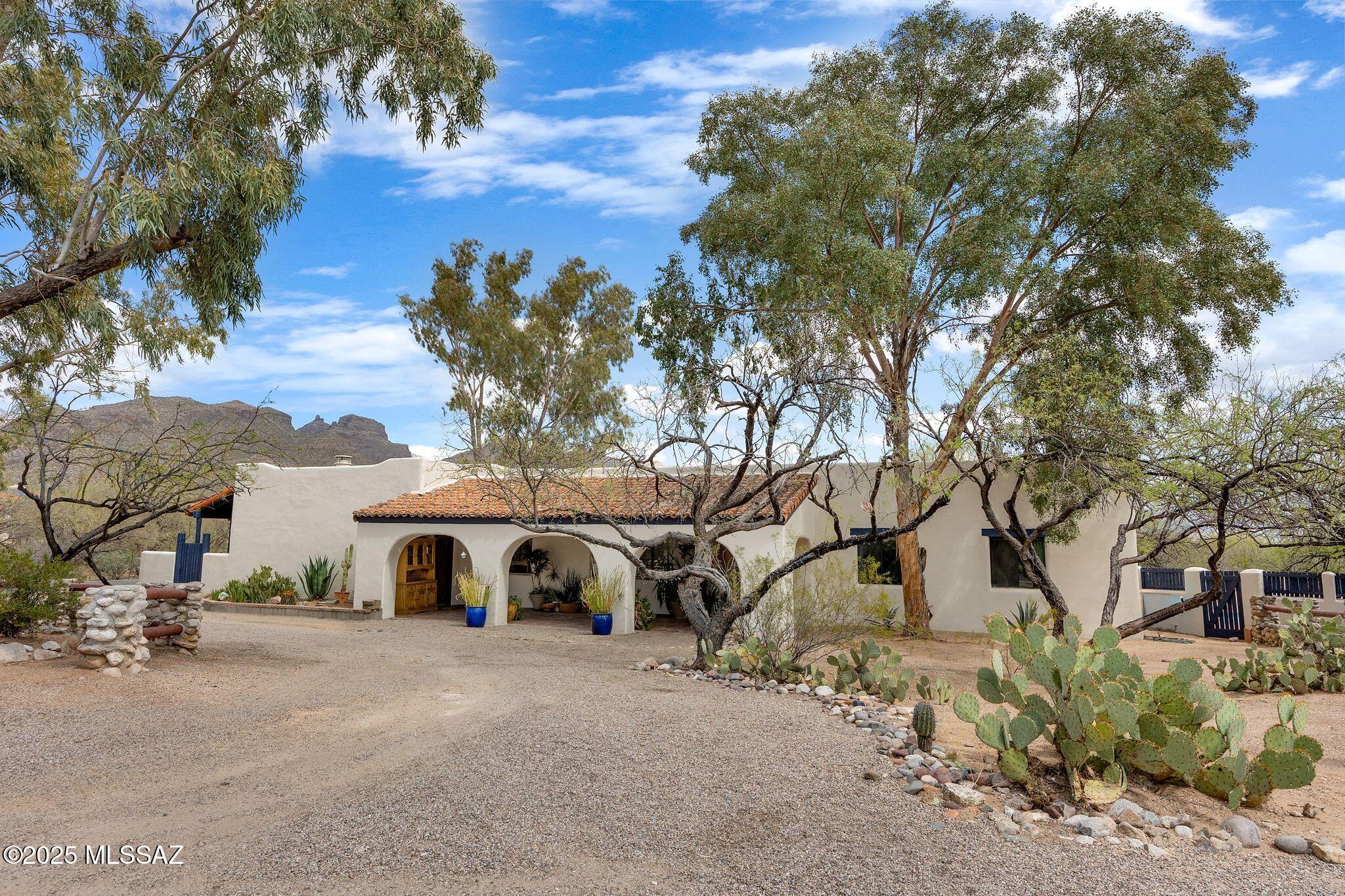 Welcome to your desert retreat near Sabino Canyon! This expansive 6-bedroom, 4-bath main house/guest house sits on nearly an acre, offering stunning mountain views, privacy, and space to spread out. Enjoy two primary suites, two fireplaces, and charming wood beam ceilings that add warmth and character. The versatile layout includes a formal living and dining room, a cozy family room, and a separate office with its own private entrance and courtyard — ideal for working from home or guest privacy. The separate guest house is perfect for multi-generational living, visitors, potential VRBO income. Step outside to your freshly replastered pool and enjoy Arizona sunsets in style. No HOA and Owned Solar too! A rare find in a premier Tucson location!