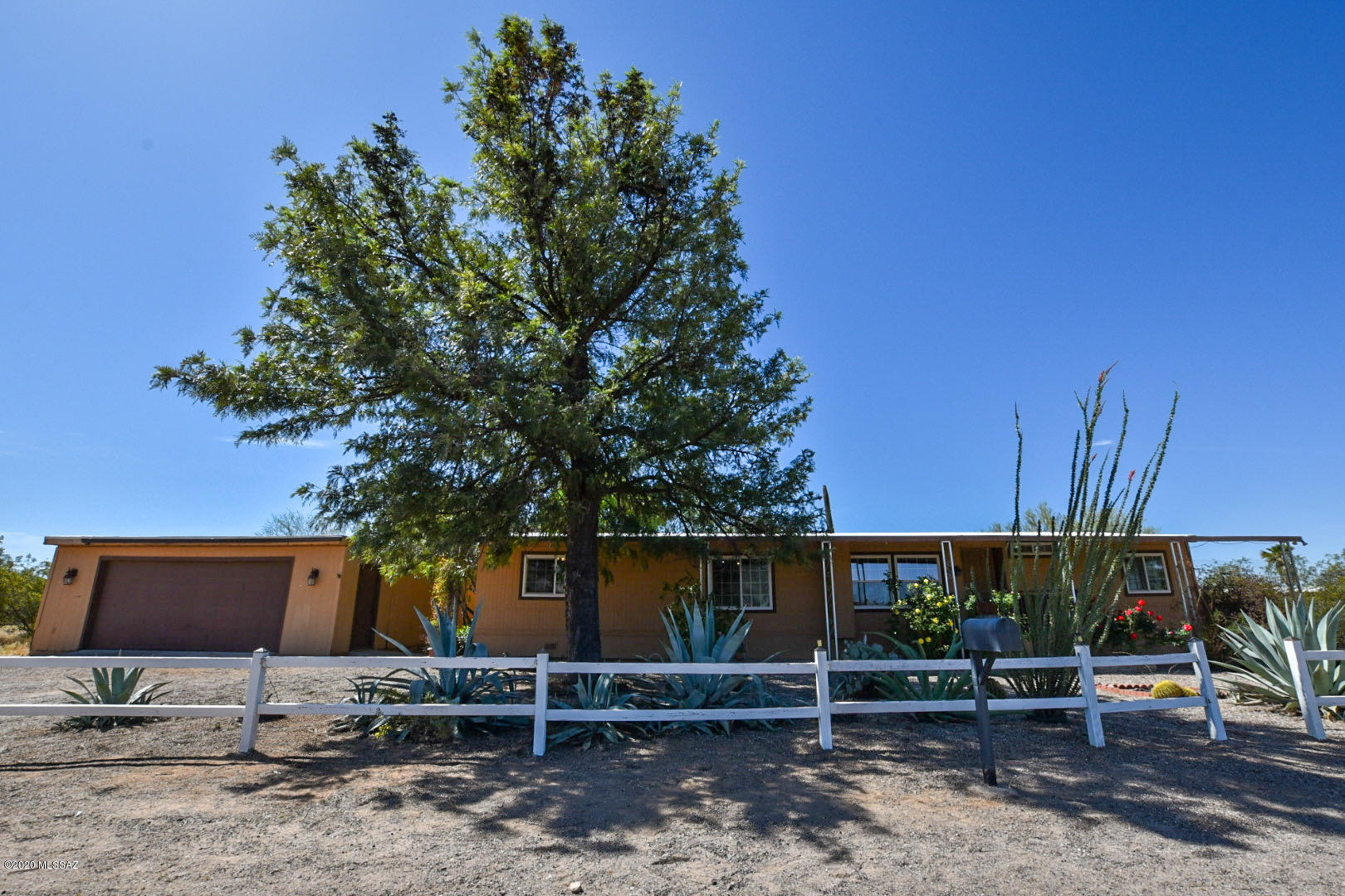 Rural Living at it's finest. Escape from the city life in this newly renovated 1680sqft 4/2 home on .99acres. Relax outside in the fenced in yard with cement patio, brick paths, and enjoy the mountain views. Beautiful landscaped with roses, fruit trees and saguaro cactus. New carpet, fresh paint, upgraded kitchen and baths. Roof re-coated with 5 year warranty, new ceilings installed in living and dinning area. Move in ready home offers a home warranty, dual pane windows, ceiling fans in all bedrooms. Detached 4 car garage with large workshop totaling 1300 sqft bring your toys and tools. Come check out your white picket fence home today. Agent owned.