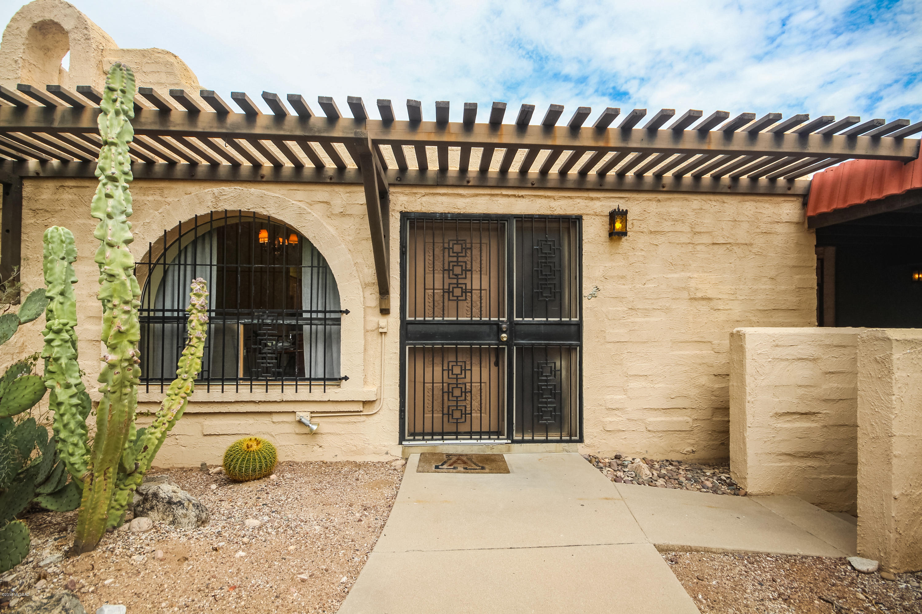Fabulous townhome in the coveted Pueblo Villas boasts Southwest style and charm inside and out! Premium location situated at the end of a cul de sac in a private setting nestled next to the lush desert. Welcoming courtyard entry leads to this cozy home, featuring beautiful Saltillo tile floors, cozy beehive fireplace, custom paint tones, and built-in bookshelves, plenty of natural light and an open floor plan. Attractive kitchen features newer cabinetry, upgraded countertops and lovely backsplash accents. Spacious master suite offers a master bath ensuite, walk-in closet, built-in bookshelves and a sliding glass door to the patio. You'll love close proximity to the community pool and spa. This is an excellent opportunity!