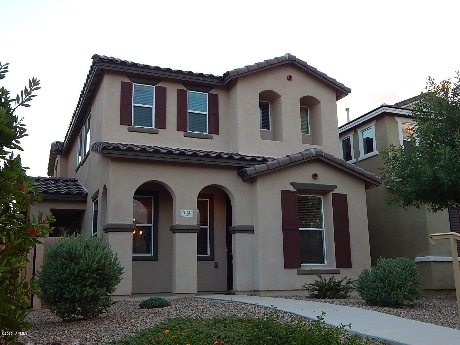 HIGH UPGRADES - LOW MAINTENANCE! Take a look at this nicely upgraded home in Rancho Sahuarita (nearly $30K in builder upgrades). Laminate wood flooring throughout the first floor, corian kitchen counters, cherry extended cabinets, black appliances, Hunter Douglas blinds, ceiling fans and a finished low maintenance side yard with extended pavers.  All this conveniently located between Clubhouse, water park, lake and the Fry's Market Place for shopping and dining. HOA fee includes maintenance of the front yard (never worry about weeds or watering again), club house, gym, water park, pools, tennis and more.  Must see!