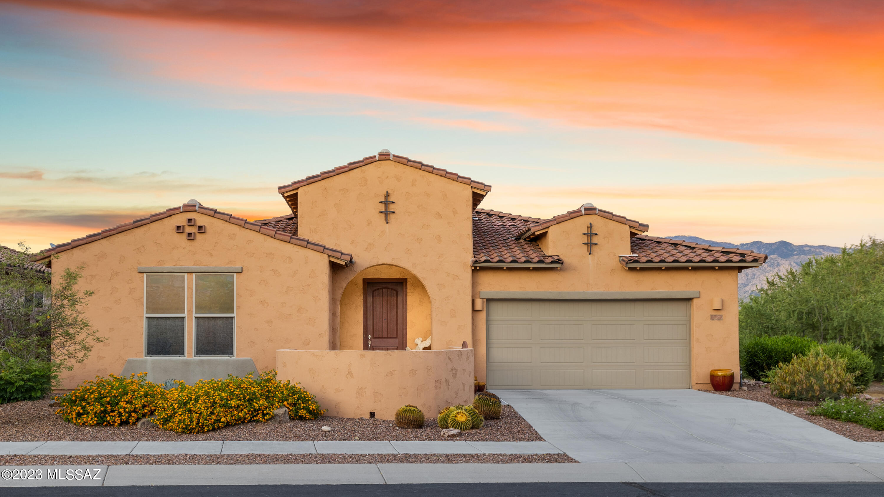Beautiful Meritage Home in the Highly Desirable Hohokam Mesa Gated Community in Oro Valley, Boasting Gorgeous Mountain Views & Abundant Green Features Harmonizing Luxury Living w/ Environmental Consciousness. Built in 2012, This Home Features a Spacious 3Bd/3Ba, 2913 SqFt Split Floorplan w/ Great Room, Two Owner's Suites, Den, Office Alcove, Breakfast Nook & Formal Dining Room. Extensive Eco-Friendly Elements Include: Trane Heat Pump, Rheem Hybrid Water Heater, Energy-Efficient Appliances, Whole House Water Filtration System w/ Water Softening Unit, Whole House Air Filtration System w/ Programmable Thermostat, Tinted Dual-Pane Windows, Spray Foam Insulation, Recessed LED Lighting, Ceiling Fans, Ceramic Tile Flooring Throughout, Blackout Blinds in Owner's Suite... Rain Gutters on Northside of Home & Native, Drought-Resistant Plants on Irrigation. The Kitchen Features Quartz Countertops, Induction Stove, Double Self-Cleaning Ovens (All Electric, No Gas to Home), Bosch Dishwasher, French Door Refrigerator, Touchless Kitchen Faucet, Maple Cabinetry w/ Pull-Outs & Crown Molding & Large Kitchen Island. Formal Dining Room & Breakfast Nook. Convenient Office Alcove & Laundry Room off Kitchen. The Split Bedroom Floorplan w/ Two Owner Suites Provides an Excellent Opportunity for Comfortable Multi-Generational Living or Private Guest Quarters. The First Spacious Owner's Suite Boasts Executive Height Double Vanities, Soaking Tub, Walk-In Shower & Large Walk-In Closet. The Second Owner's Suite has Living & Sleeping Space, a Tub/Shower, Executive Height Vanity, & Large Walk-In Closet. The Lot is Situated w/ Common Area to the South & Open Desert Space Behind. Enjoy Arizona Evenings from the Welcoming Front Courtyard & Exceptional Mountain Views from the Backyard, Featuring a Covered Patio, Extended Pavers & Array of Beautiful Plants, Bushes & Flowers. Only Moments Away From Catalina State Park, Biking Trails, Community Parks, Tennis Courts, Oro Valley Hospital, Medical/Dental Facilities, Shopping, Dining & Entertainment. Experience this Stunning Home, Where Comfort Meets Eco-Consciousness Amidst the Breathtaking Backdrop of Oro Valley's Natural Beauty.
