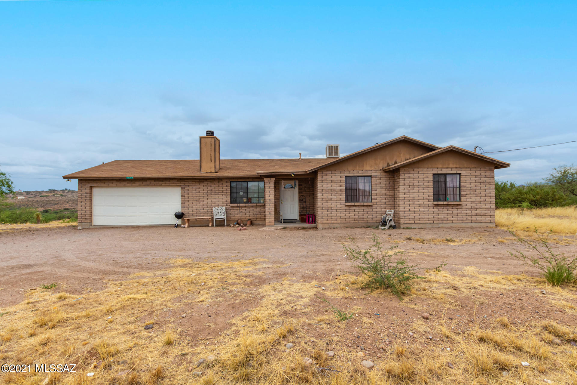 Take a look at this charming property nestled in a vast area with a 2 car garage and endless potential. Interior boasts a bright living room w/wood-burning fireplace, warm tones palette, tile flooring, and ceiling fan. The eat-in kitchen is equipped with ample oak cabinets, matching appliances, pantry, and backyard access. Main bedroom has vaulted ceilings, abundant natural light, soft carpet, and private bathroom w/double sinks. Sizable bedrooms are well-lit and have closets. At the back, you will find a cozy covered patio with amazing mountain views. Get creative in this expansive piece of land and make it yours!