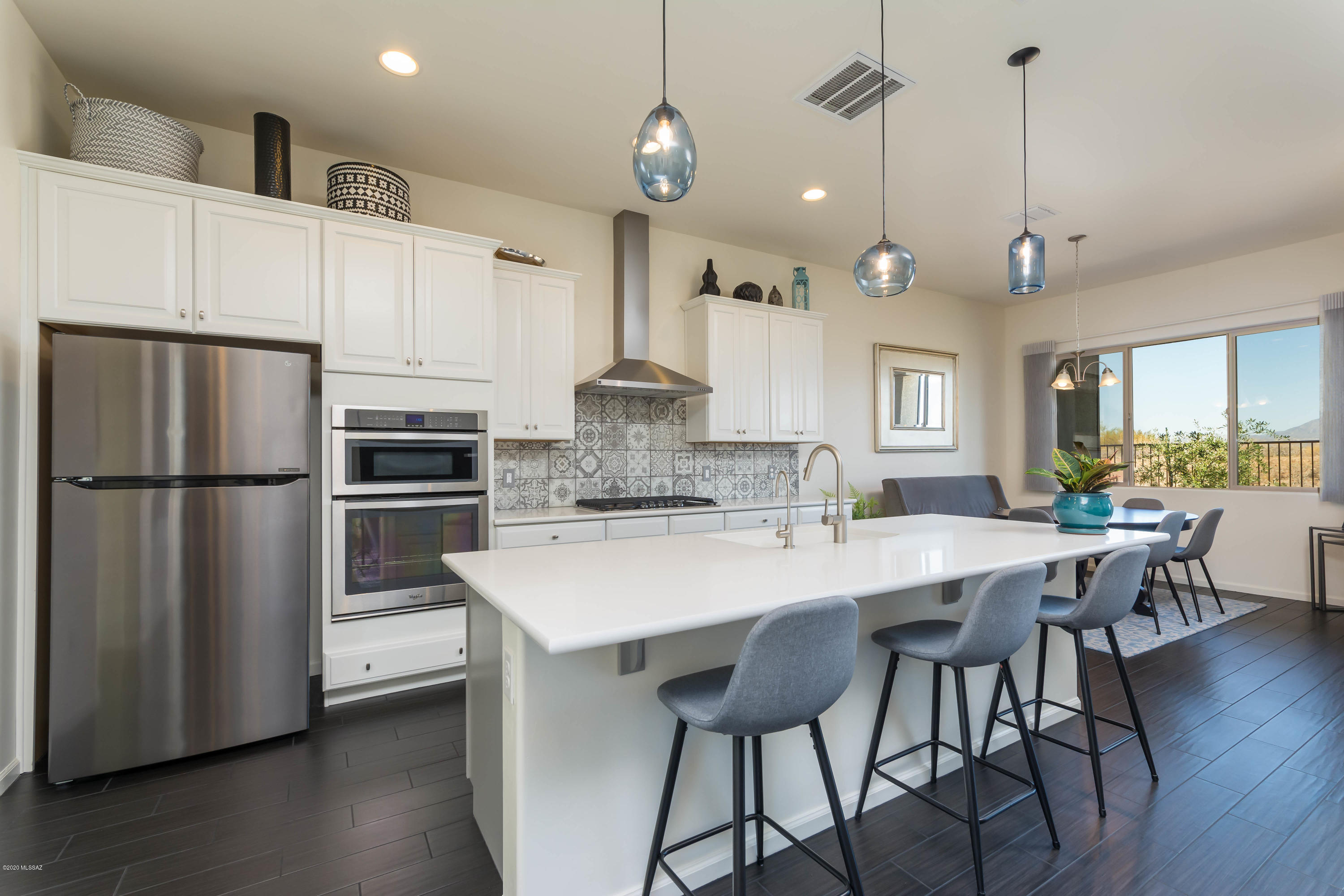 Immaculate & move-in ready 1,799sf 2BR/2.5BA+den/office. This Luxury Patio Home at Gated Ridgeview at Vistoso Trails has magnificent Catalina Mountains views during the day & sparkling lights at night. Enjoy relaxing in your patio hot tub while taking in the solitude & views. Enter through Travertine-tiled courtyard to Open Great Room plan featuring large island/breakfast bar, Quartz counters, gas cooktop & dining area.  Porcelain Wood Plank Tile throughout. Master suite has walk-in shower & large walk-in closet. On opposite side of home is a spacious 2nd bedroom & hall bath w/tub/shower. Close to community pool & spa. Biking trails nearby & convenient access to golf courses, restaurants & shopping. HOA incls Community Pool & Spa, Front Yard & Irrigation, Exterior Paint & Roof Maintenance.