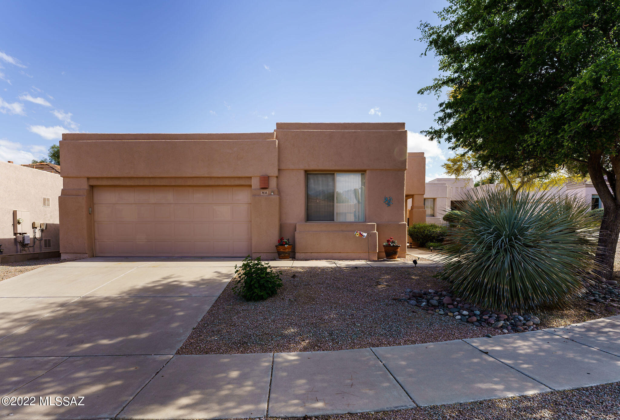 Location, Location, Location.  This home has one of the most popular floorplans. The kitchen has an abundance of cabinetry and raised bar with seating for 4.  Large area for dining table, side by side refrigerator with water/ice and built in microwave.  The kitchen is open to the large living room with a ceiling fan and sliding glass door to the rear yard. The master bedroom has a walk in shower, dual sinks and a walk in closet.  The laundry room has an overhead shelves and a washer/dryer.   2 car garage. Covered patio with an extended brick paver patio. Roof coated within 3 yrs.  Gated Community with pools and spa.  Recreation and entertaining area.  Nearby shopping, restaurants, Udall Park, close to hospitals, and easy access to every part of Tucson.