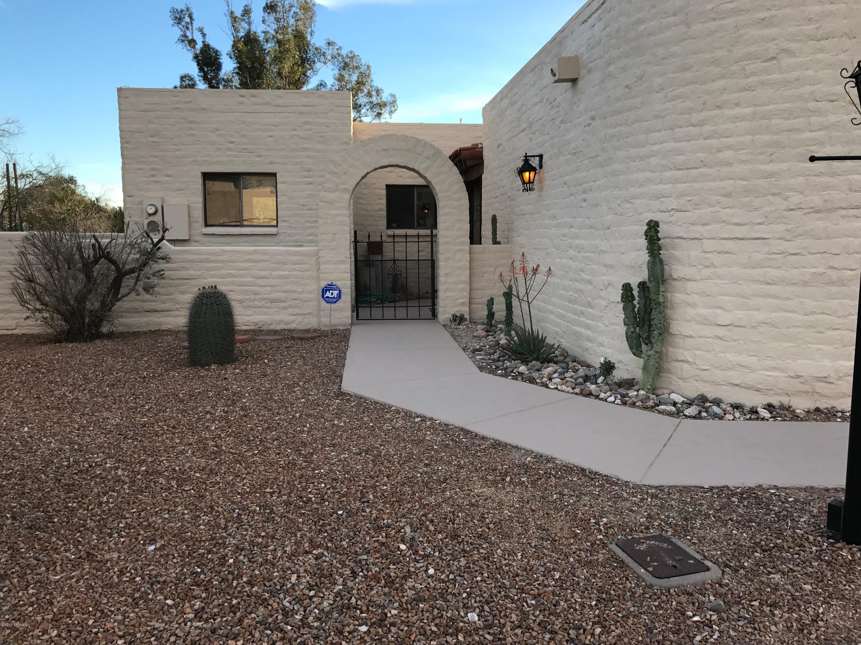 Expanded 2 BR 2 BA Fairfield TH. 1747 sq ft. Corner fireplace in great room and sliders to both rear and side patios. End unit overlooking large common area to the east Rincon Mountain views. One of the most desireable lots in the neighorhood. Near swimming pool and desert wash for pet walking and easy exercise. Expansion offers large front bedroom and office/sitting area off the master bedroom. Tile floors, new carpeting in bedrooms, fresh paint throughout. Very private large patios. This quiet, popular enclave of 40 homes is situated in mid foothills and gives easy access to U of A, Sabino Canyon recreation area, golf, restaurants and shopping. Easy to show. Keysafe accessible.