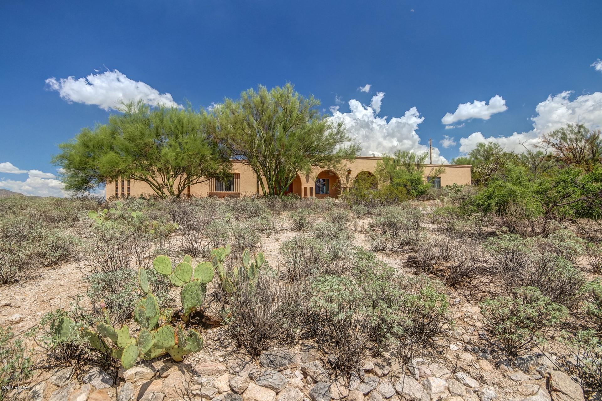Bring your visions to life in this amazing hill top territorial style home surrounded by pristine natural desert and majestic Catalina Mountain & Rincon views! Tons of charm and comfort throughout with large picture windows and neutral paint tones. Masterfully designed kitchen offers a plethora of cabinets, ample counter space, center island, and picturesque desert views! Beautiful Mexican tile laid throughout the kitchen opening up to the family room with a handsome brick fireplace. Spend your time in the backyard oasis as you relax under the covered patio, lounge in the refreshing pool, rejuvenate in the spa, or soak up the sun and breathtaking unobstructed mountain views. This home is move in ready and waiting for you!