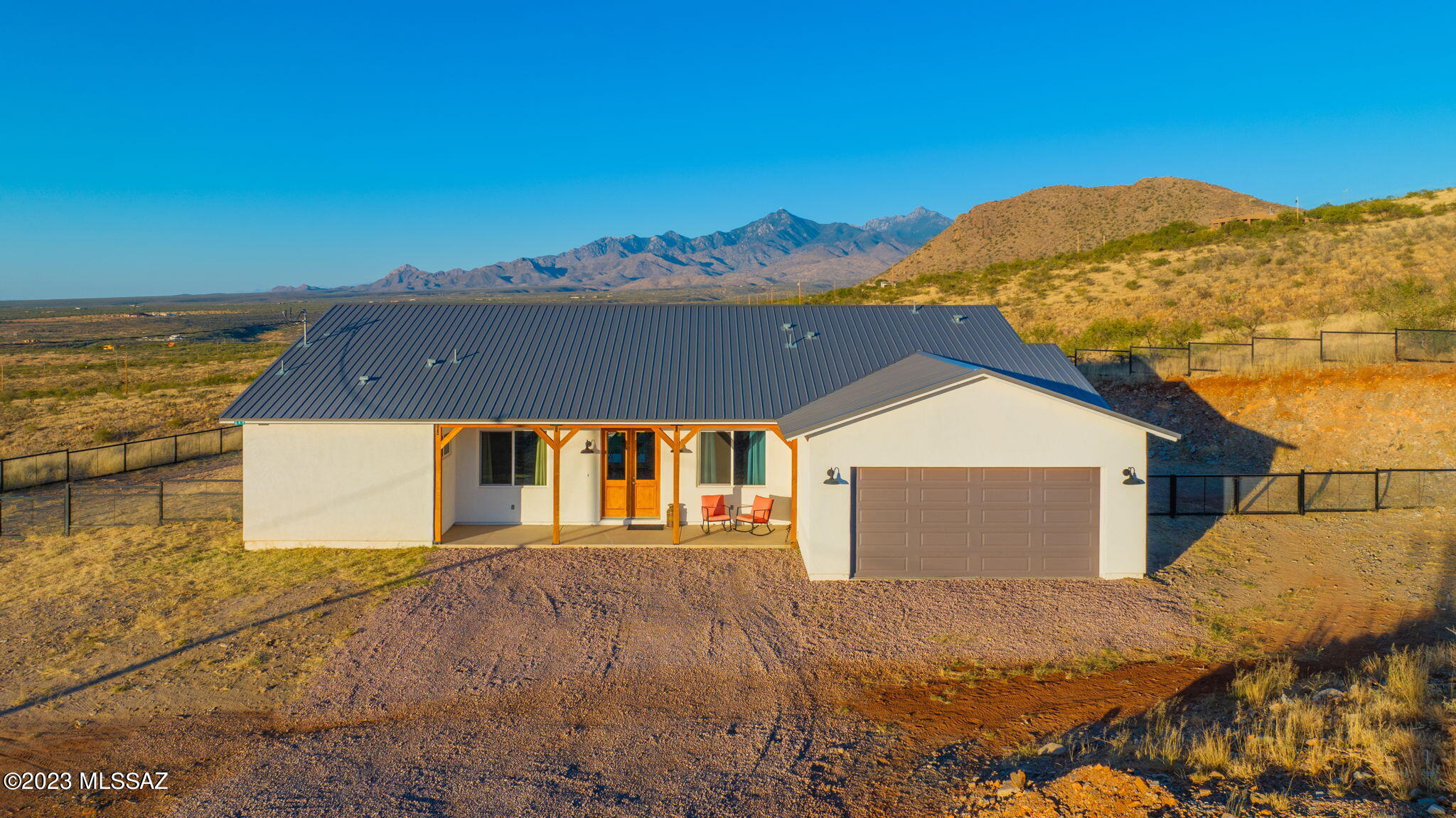 This modern ranch style home is immaculate! With 3.29 acres of land and incredible scenic views of Santa Cruz County. This home features 3 bedrooms, 3 full baths, 1 Den and 1,997 sq. feet. With vaulted ceilings, custom cabinetry in the kitchen, large island, walk-in pantry, dry bar, granite counter tops, and ceramic wood looking floors. The primary bedroom is very spacious, including a walk-in closet, dual vanity in the sink area, jetted tub, and shower. As you step outside onto the expansive back covered patio, you will see the unobstructed views, feel the comfort of privacy a fire pit, and BBQ area. The backyard is perfect for gatherings, and even has plenty of space to park an RV. This home will truly not disappoint.
