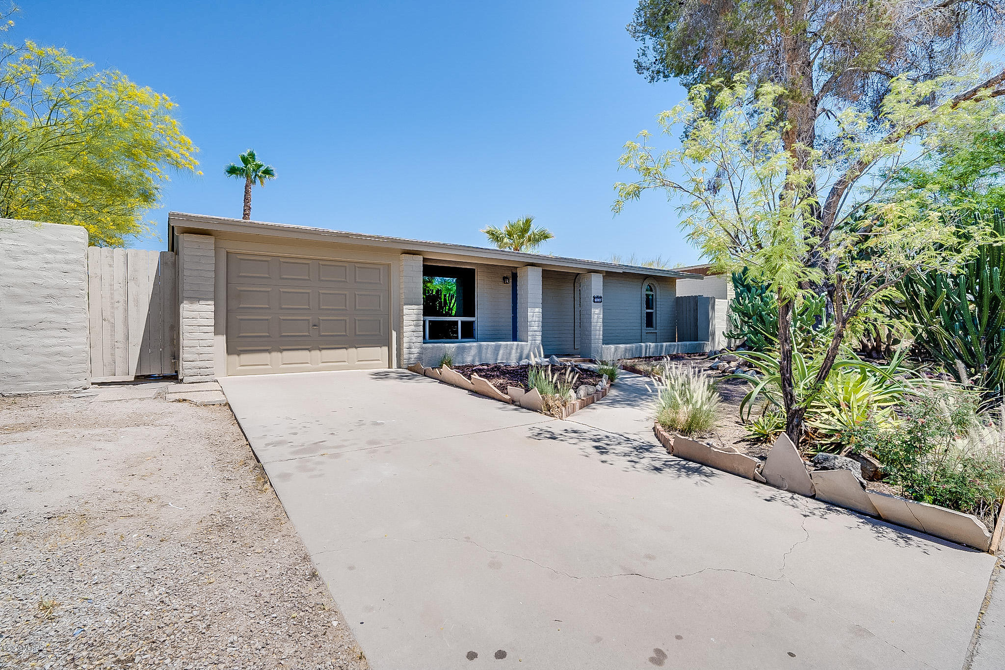 Perfection! This tastefully remodeled northwest home has been completely updated for a modern lifestyle. Attention to detail is at the heart of this home. As you enter the home, you will be enchanted by the atmosphere that is flooded with natural light, fresh paint, easy care Concrete flooring with new baseboard throughout, no immediate neighbor behind and mountain views. The gorgeous kitchen boasts new all-wood, soft close cabinets, quartz counters and stainless-steel appliances. Both Bathrooms are beautifully remodeled. New A/C, new dual pane windows, new roof singles and LED recessed lighting are some of the other updates. This tastefully remodeled home has two living areas! Entertain under the covered patio and enjoy the sparkling pool in you huge walled-in back yard. The large laundry room has plenty of space for storage. No HOA! Great location, convenient to shopping, hospital and I-10. This home has a ton of charm, and is sure to wow you when you walk through. 3D Virtual tour of this home is available under photos. (https://my.matterport.com/show/?m=3WTv5SRAPW7&mls=1)