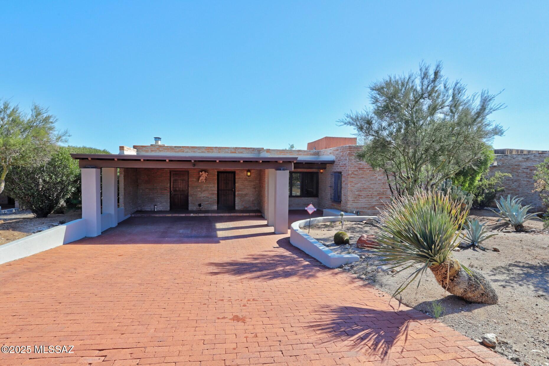 CHARMING LA QUINTA BUILT HOME IN SERENIDAD: This burnt adobe home features 1765 square feet with 2 bedrooms, 2 baths.  The side by side living-family opens to a large dining room creating a great entertaining space.  There is saltillo tile throughout & lots of Mexican tile accents. Some additional features include tiled windowseats, high beamed ceilings & lots of built in cabinetry. The home has an East West orientation with East facing covered back patio perfect for your morning coffee. The homeowners assocition includes a lovely pool & Ramada.  The reasonable HOA fees include maintenance of the  common areas, road maintenance & trash collection. This is an estate sale, title work has been started. Please escrow with Claire Loughran at Stewart Title, 520-258-4020. New Heat Pump August 2025
Roof Recoated and Membrane added where necessary May 2025
Both the heat pump and roof carry a 5 year Warranty