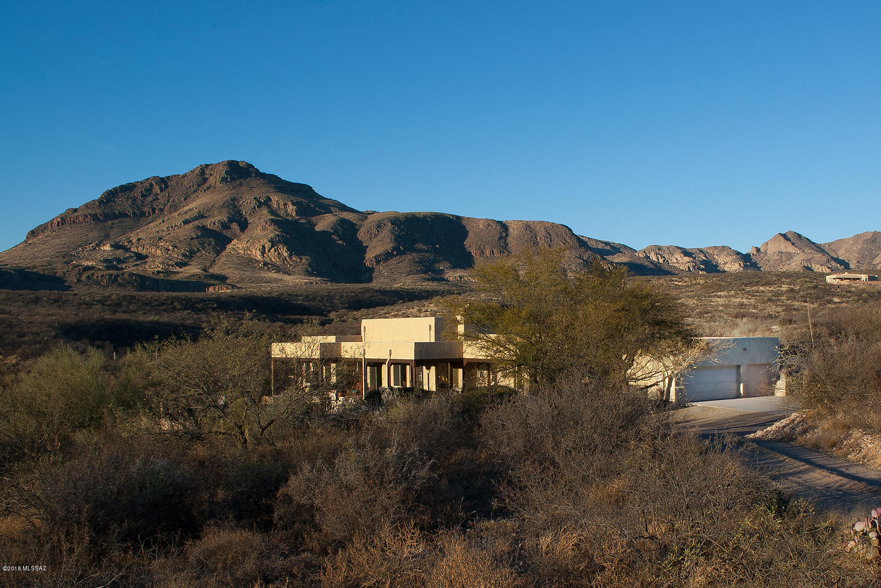 Situated on six secluded acres with own private road,  with great mountains views and not close to Frontage Road, this custom built home offers an open concept floor plan including 3 BR, 3 BA, high ceilings, gas fireplace and tile flooring and Mexican pavers in great room. Lots of light and exceptional mountain views. Pool, spa and water heater are solar powered.  There's  a three car garage and private well. Only minutes to Tubac. Horses welcome. Additional 5 acres included in price. Bring all offers.