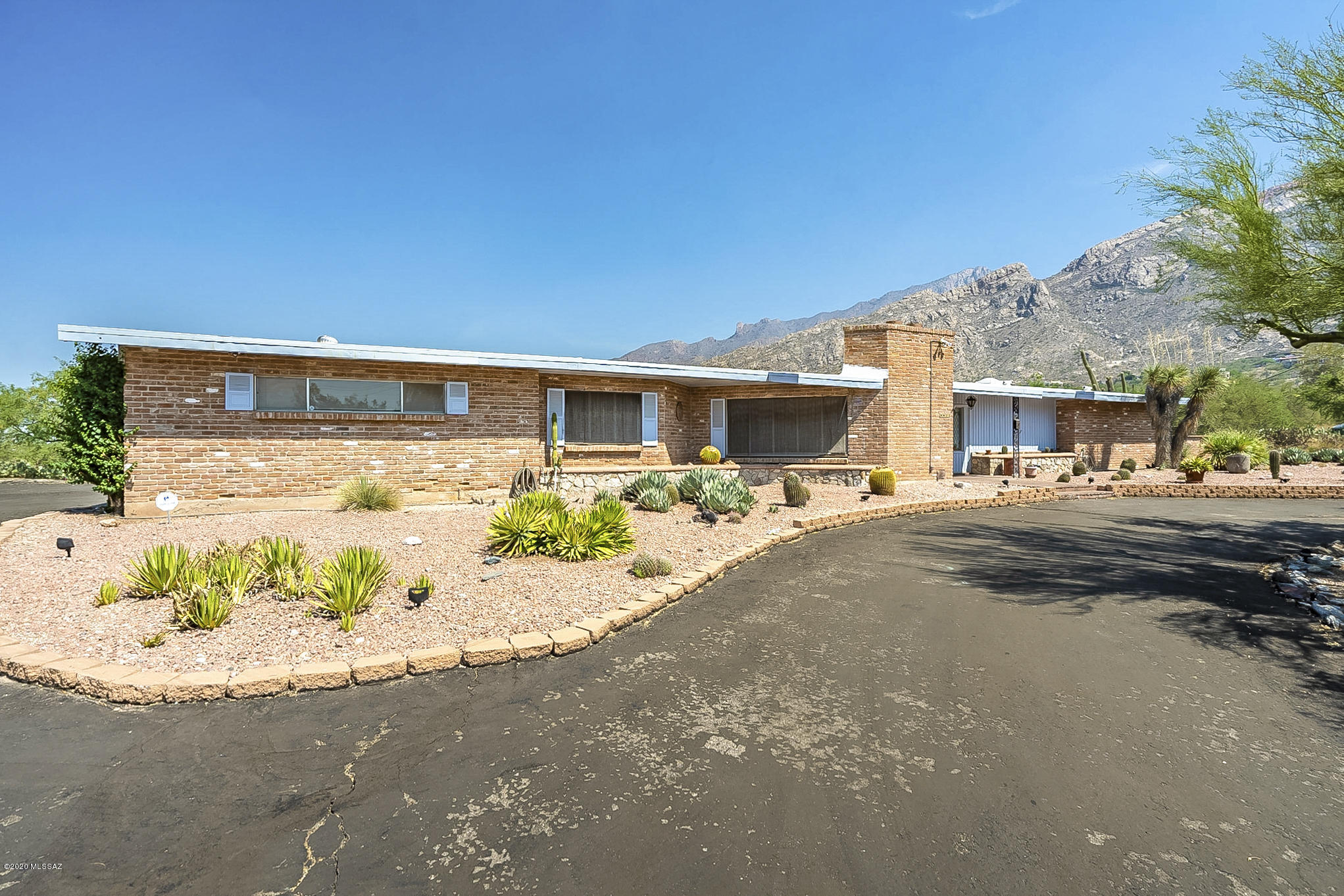 Great location with Catalina Mountain views! Great opportunity to be in school district 16. Burnt Adobe ranch style home, 3 bed 2 bath, 2 car garage. New AC, roof has been re-coated recently. The hot tub in the back yard is  in AS IS condition.