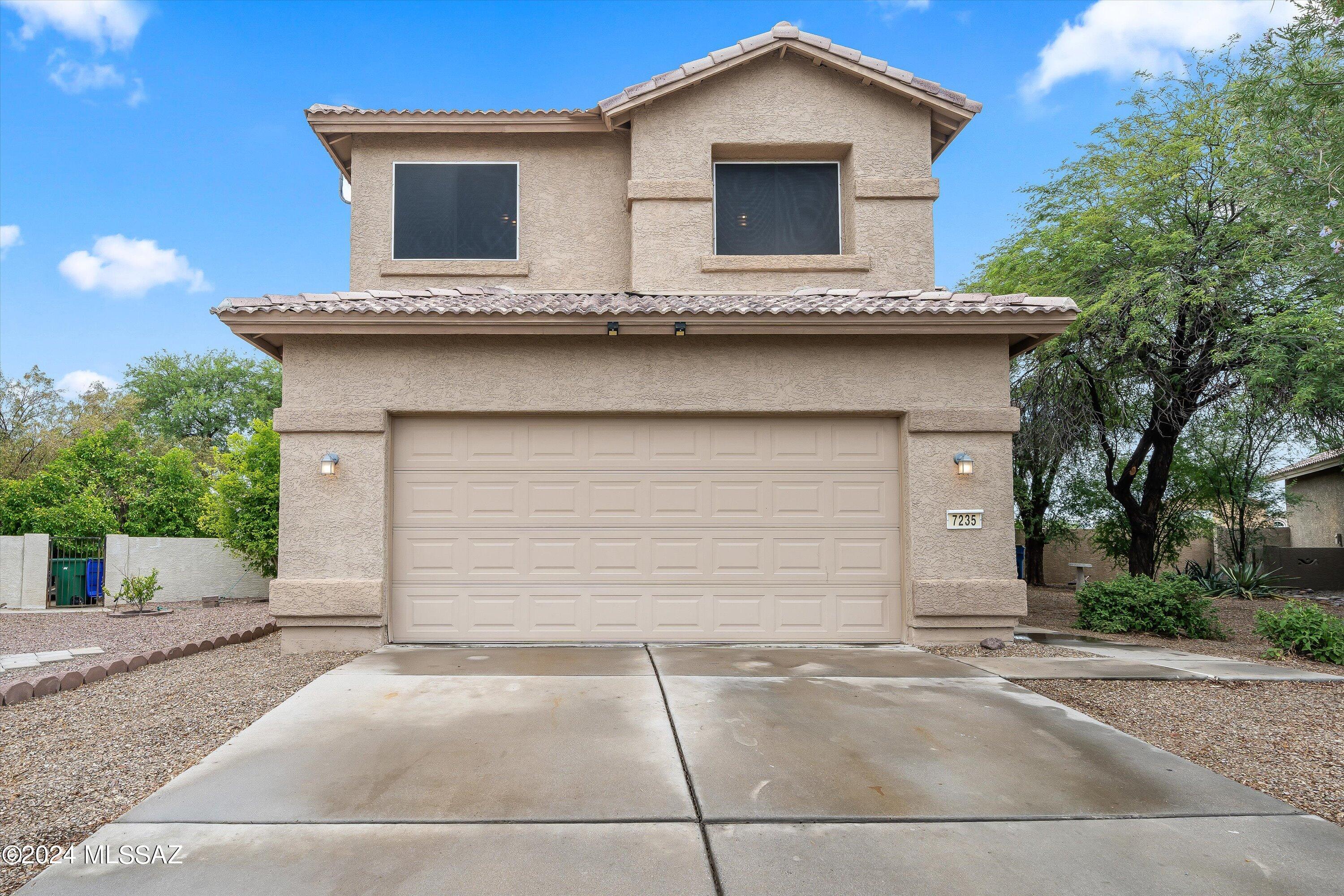 UPDATED and ready for you to enjoy in the conveniently located Continental Ranch neighborhood with two community POOLS! Walk in to the open living area with a soaring ceiling to the second floor and new luxury vinyl plank flooring, then make your way into the second living area with large kitchen boasting updated cabinets, black stainless steel appliances and quartz countertops. The new carpet leads you upstairs to the four bedrooms, including an oversized primary suite with a separate sitting room that can be used as an office space, sitting area, or home gym! The primary bath has a dual sink vanity, soaking tub, and separate shower. The extra large pool-sized backyard has a covered patio, raised planters, a dog run, low-care gravel and views of the Catalina mountains (see more) and Sombrero Peak! Enjoy your privacy with no rear neighbors to the south and a common space sitting area with benches to the west. Just a short distance to The Loop, Continental Ranch has two pools, a community center and parks, plus I-10 is conveniently just minutes away! Note that, according to the Continental Ranch HOA, the rear wall can be raised to 6' high, if matched to existing stucco and approved by the HOA.