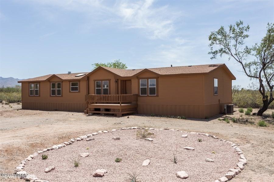 This is a Fannie Mae HomePath Property!  With 2496 sq ft of living space, this spacious manufactured home sits on 4.58 acre lot surrounded by natural desert, has 5 bedrooms, 3 bathrooms, laundry room, and large front & backyard with mountain views. Spacious kitchen with plenty of cabinet space, breakfast area & formal dining area. Family room with fireplace,  master bathroom with dual sinks, garden tub & walk-in shower. <FONT COLOR=RED> Recently painted interior & exterior, installed NEW carpet, NEW vinyl,  NEW kitchen cabinets, & NEW SS Appliances. </FONT> Located close to I-19, shopping, restaurants and much more!  Incentives are now available on this property! Up to 3% closing cost assistance is available on this property for eligible buyers! To qualify, buyers must reside in the home as their primary residence.