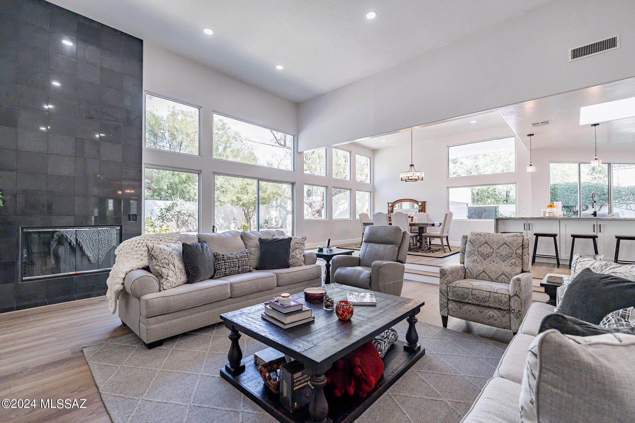 Welcome to 2345 E Elm St, an exquisite modernized masterpiece that blends modern and classic elements. This 5,130 sq ft home is situated in one of Tucson's most beautiful and beloved areas, Blenman-Elm Historic District. As you step inside, be welcomed by an expansive open floor plan with floor-to-ceiling windows that flood the interior with natural light. The spacious living areas are perfect for entertaining and guests to move effortlessly from room to room. The gourmet chef's kitchen is outfitted with a large center island and ample counter space for all your culinary needs. This stunning residence features 4 bedrooms, 5 bathrooms offering ample space and sophistication. This home includes a dedicated basement to relax and experience the ultimate movie night or greatest way to entertain with games. Relax in the luxurious primary suite, an opulent en-suite bath with dual vanities, a grand glass shower and a serene retreat creating a sanctuary of comfort that transforms into your own outdoor space offering a private patio. Enjoy seamless indoor-outdoor living with large, expansive sliding doors leading to the outdoor living space. Enjoy a bit of magic with the beautiful koi swimming pool which can easily be converted to make it your own. This property effortlessly blends luxury living with the best lifestyle in Central Tucson also conveniently located near University of Arizona and Banner Hospital. This is without a doubt the best quality home available for the price in today's market.