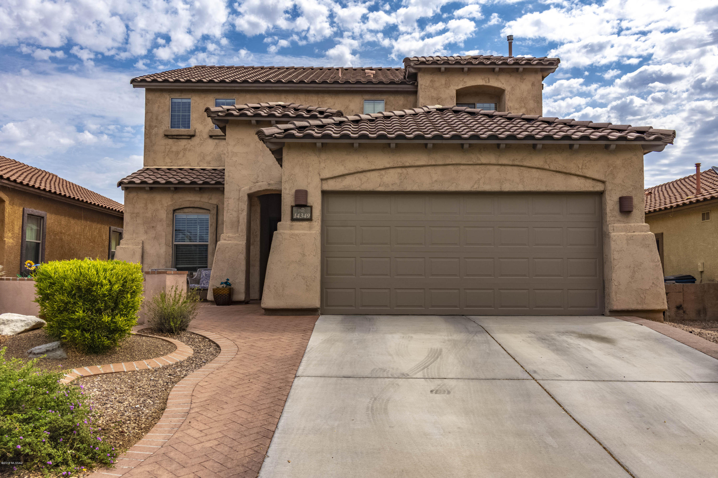 You will not want to miss this gorgeous 4 bedroom 3 bathroom home in the heart of Rancho Sahuarita conveniently located across the street from the neighborhood park!  Spacious open floorplan boasts a formal living room, great room concept kitchen and family room, and bedroom with full bath on the main floor. Kitchen and bath cabinetry has been upgraded throughout as well as front door and pantry doors to match.  All bedrooms upstairs have giant walk-in closets and a separate loft area can be used countless ways, currently making the perfect playroom.  Backyard is built to entertain featuring covered patio, flagstone, pavers and artificial turf.  This home has been lovingly maintained and can be yours today as you enjoy all the amenities Rancho Sahuarita has to offer