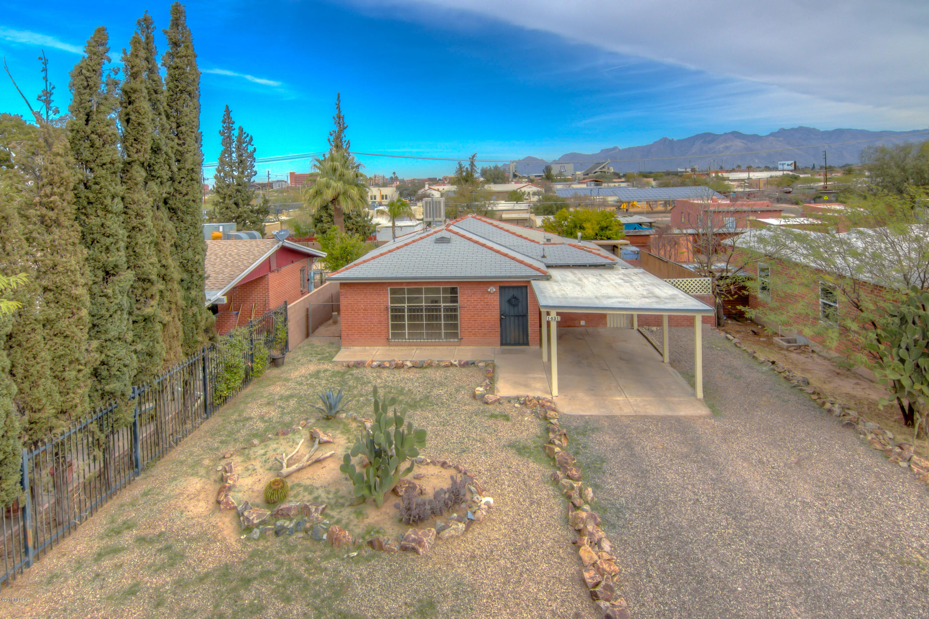 Charming red brick home minutes from U of A campus, downtown, shopping restaurants and Aviation Parkway.  Newer evaporative cooler, water heater and furnace. Security bars on all windows.  Huge R2 lot with potential to build another unit on the property. Home is clean and move in ready!