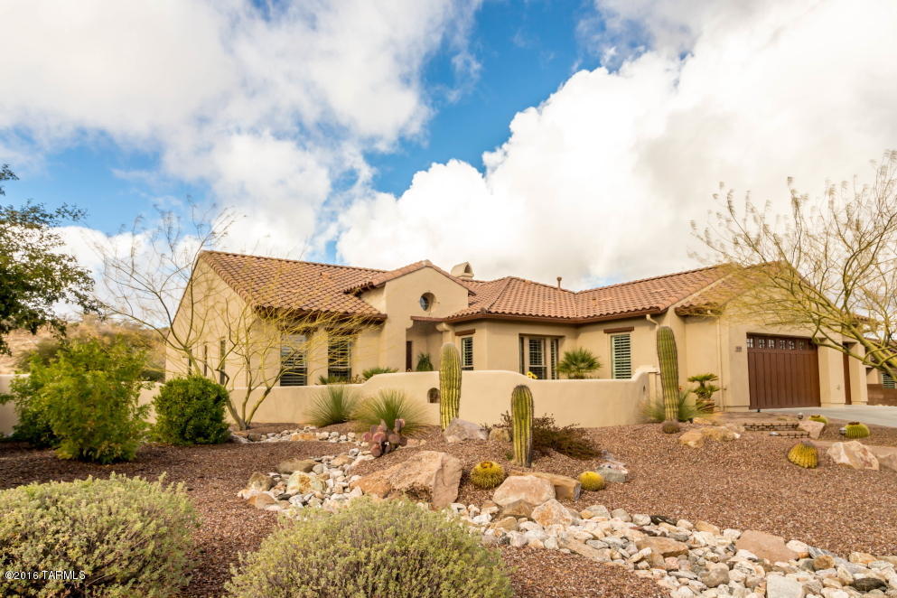 Casual elegance in The Preserve, the luxury home community of SaddleBrooke. This great room Sabino plan optimizes space. Custom features include wood floors, plantation shutters, automatic solar screens inside and on the patio plus extra ceiling lighting most rooms. Stone wall with media center and gas fireplace. Centrally located kitchen with cherry wood cabinets and slab granite counters & back splash. Stainless steel appliances include the built-in refrigerator.  Security system and soft water system. Extensive brick in front courtyard and covered back patio with built-in gas barbecue grill. Enjoy the quiet peaceful setting of the desert hill behind the property. Located on a quiet street with mountain views. Priced thousands below new build. Start your resort lifestyle and move in now.