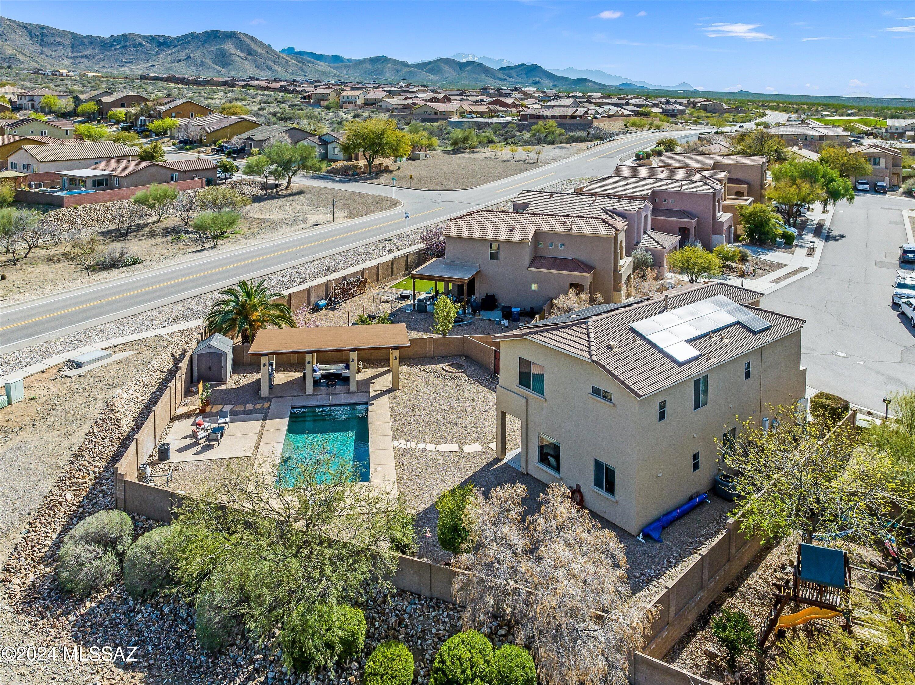Escape the hustle and bustle of city life in this remarkable house, boasting hidden treasures beyond mere sight. Nestled on a corner lot, it showcases a built-in ramada and patio landings encircling the pool. Elevating your pool experience is the wave machine, enhancing relaxation amidst stunning 360-degree mountain vistas. Meticulously maintained and thoughtfully updated, this home exudes warmth and care. Enjoy the privacy of the media/den off the master. Explore its many highlights in the accompanying document section, including recent HVAC upgrades, new laminate flooring, and modern appliances installed within the past few years. With its pristine condition, this home awaits your presence to relish life beneath Arizona's expansive skies, enveloped by breathtaking mountain panoramas