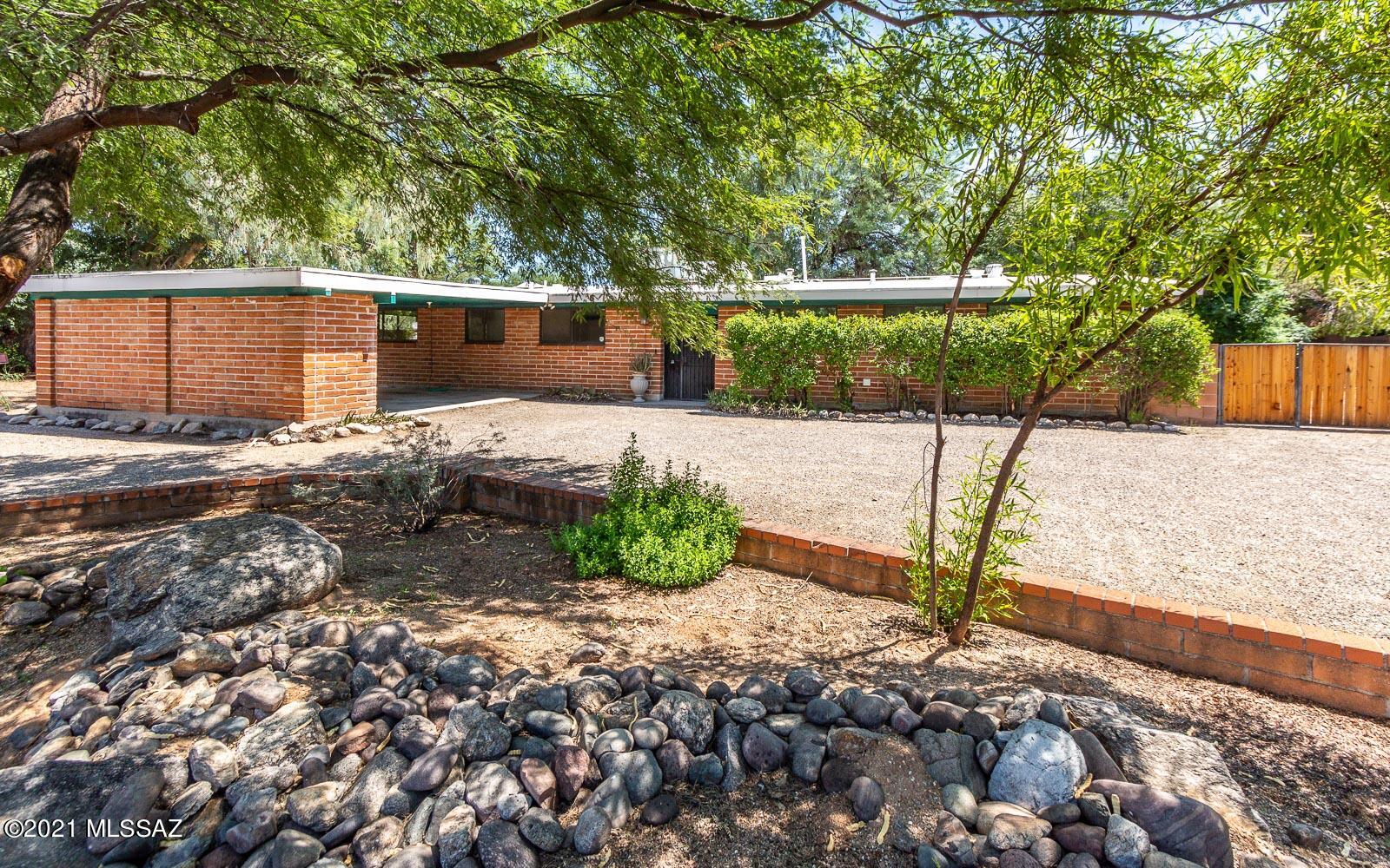 Spacious burnt adobe home in popular Indian Ridge historic district. Historic status allows for a significant reduction in property taxes. This home is situated on a large 0.42 acre lot with plenty of mature trees. The backyard features a long, covered patio that spans the length of the home, a block wall, and 2 double gates with lots of space for a RV. The interior has been freshly painted. Newer HVAC and water heater. The bonus room has a separate entry. The neighborhood has an active voluntary HOA that organizes several events. There's also neighborhood pool memberships available.