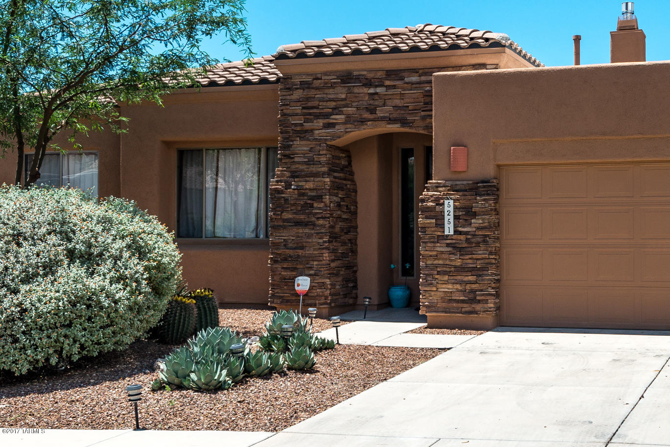 You'll love the great curb appeal with stacked stone wrapping in the front & low care landscaping. Picture window frames the backyard oasis with flagstone covered patio,pebble-tec pool w/palm trees & built in BBQ. Remodeled kitchen has gas cooktop, blt in microwave & travertine backsplash. Large 3.5x14 ft island has lots of cabinets. All the bedrooms have engineered hardwood floors with travertine tile throughout the rest of the house. Master bath has granite vanity tops, 2 under mount sinks with new fixtures, jetted tub & rain shower w/ travertine surround & smooth pebble flooring. Remodeled guest bath with granite vanity, under mount sink, new fixtures, picture frame mirror, dual flush toilet, travertine surround tub. Enjoy the FP from the dining area, 2 living areas & the kitchen.