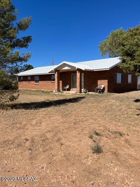 Well kept burnt adobe home with a metal roof in Pearce. Located on Hwy 181 close to the Mustang Mall and Sandy's with gorgeous views of the surrounding mountains. Property is on just shy of 3 acres with two Large shops (30x40x12) with 8'' doors. House has extra wide doors, walkin closets, a roll in shower, spa tub, floor to ceiling kitchen cabinets, Arizona Room, Living Room with a fireplace and so much more.