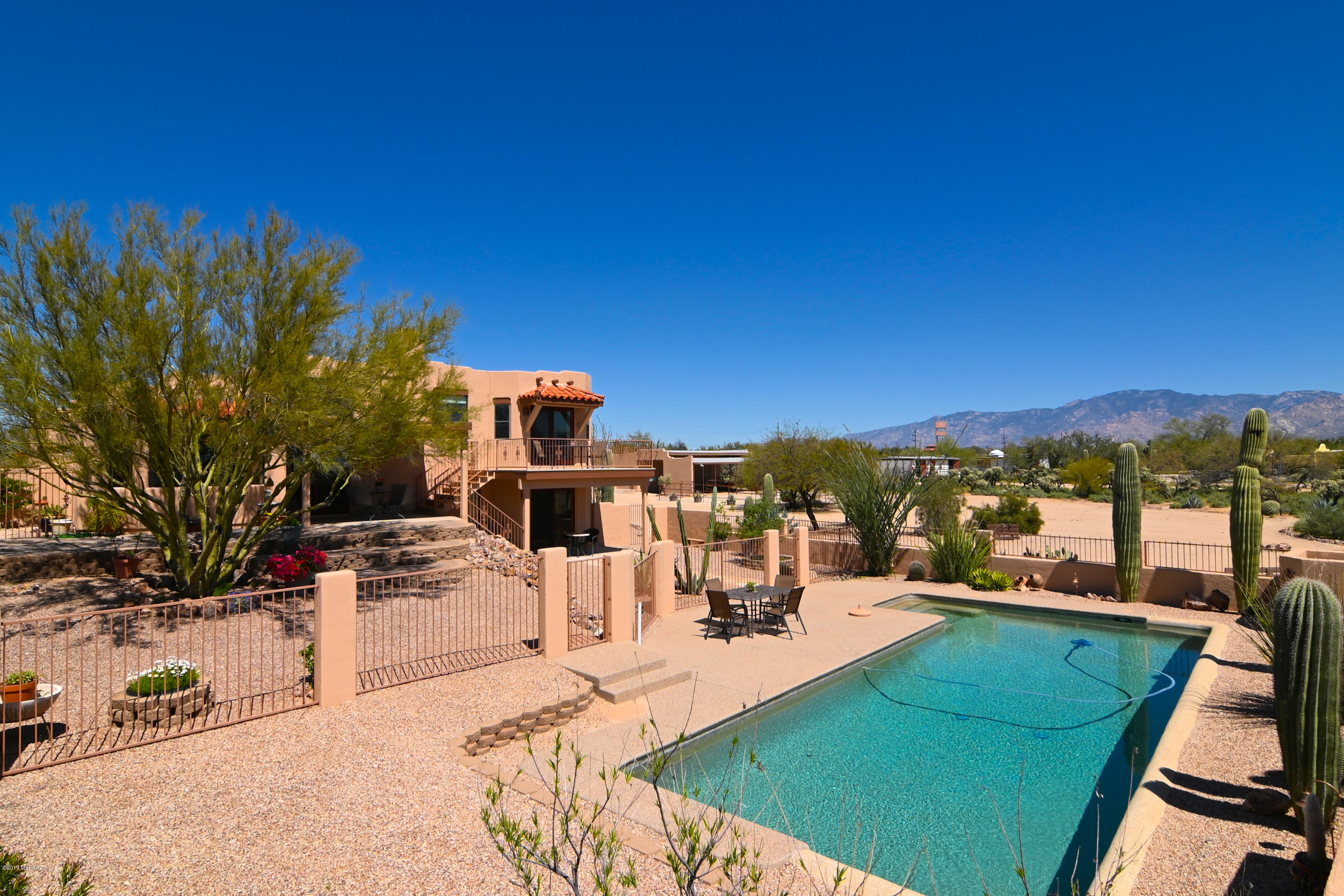 Extremely Private Northwest Tucson Home with Catalina Mountain Views & a Tranquil 3.3 Acre Setting of Pristine Sonoran Desert. Stunning Living Room with Soaring Wood Plank & Beam Ceiling, Clearstory Windows & Inviting Beehive Fireplace. Bright Kitchen with Quartz Counters, Center Island, SS Appliances, Bosch Range & Tile Backsplash. Custom Knotty Alder Cabinetry carried through Kitchen, Baths & Laundry. Breakfast Nook with Bay Style Windows & Dining Room for Entertaining. Open Family or Media Room. Master Suite with Walk-in Closet & Deck with Views. Elegant Master Bath with Quartz Counters, Soaking Tub, Shower & Double Sink Vanity. Private Outdoor Living Space with Pebbletec Pool, Decks & Extended Patios. Oversized 2-Car Garage or Workshop with 220V. RV Hookup. Meticulous Move-in Condition
