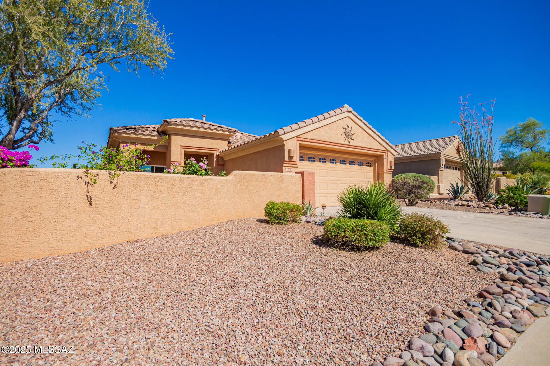 Front courtyard with views of the Catalina Mountains. Freshly painted with new carpet, this expanded Aurora model offers 1,705 sq. ft. The kitchen includes a gas stove, island with bar seating, pull-out cabinetry, pantry, eat in area and all appliances included. Primary suite has two walk-in closets,  bathroom with double vanities plus a relaxing tub/shower combination while the versatile bonus room provides space for hobbies or an office. 2nd bedroom with Murphy bed Garage includes a utility sink built-in cabinetry for extra storage and outside you'll enjoy a screened-in patio and fully fenced backyard overlooking a  desert wash. Located down the street from the clubhouse with golf, tennis, pickleball, pool, restaurant, social activities and much more! Close to hiking and biking trails.